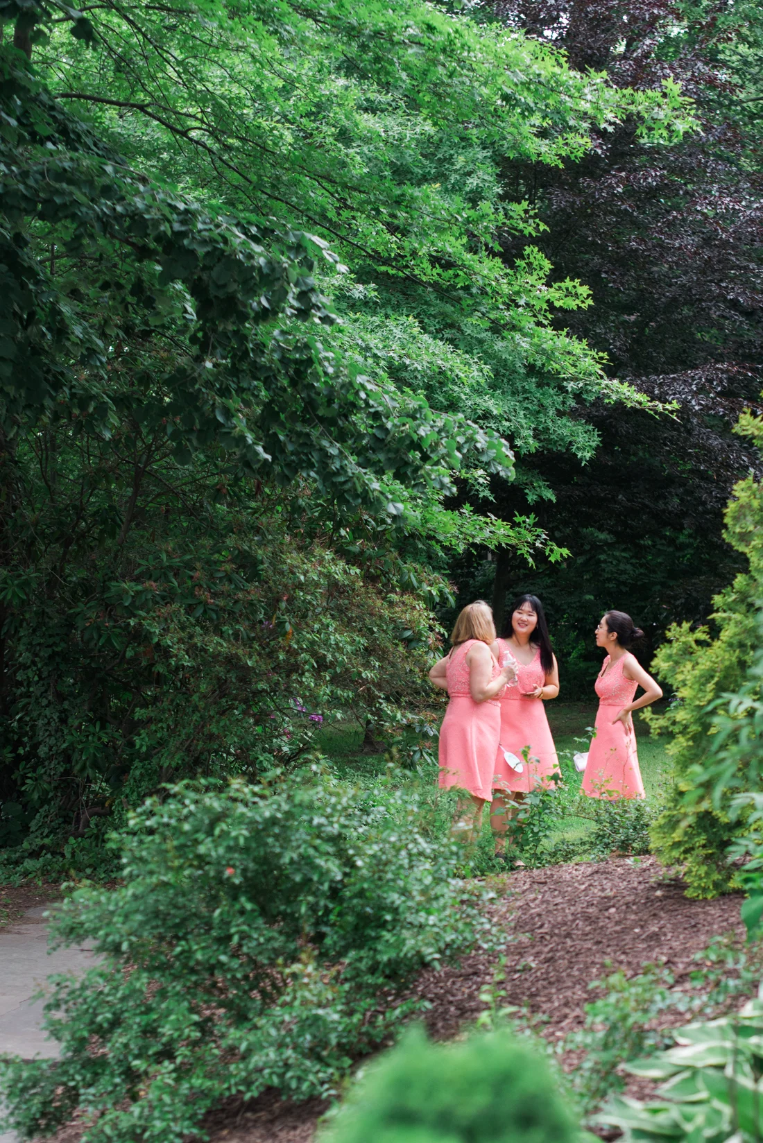 Ephemera Designs Three Bridesmaids off in the Distance Outside in Bright Pink Dresses