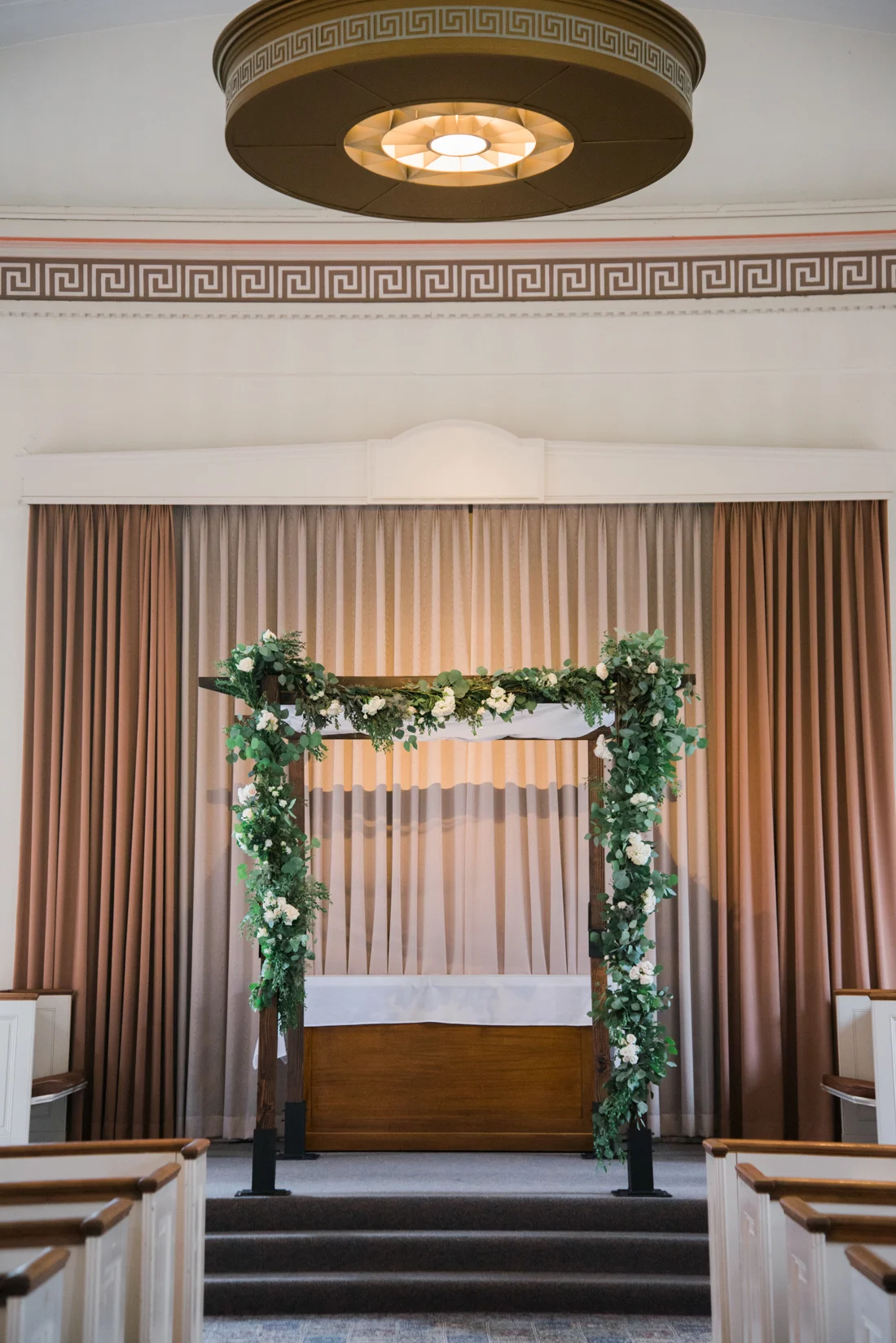 Ephemera Designs Inside Ceremony Space with White Blossoms & Greenery onChuppah