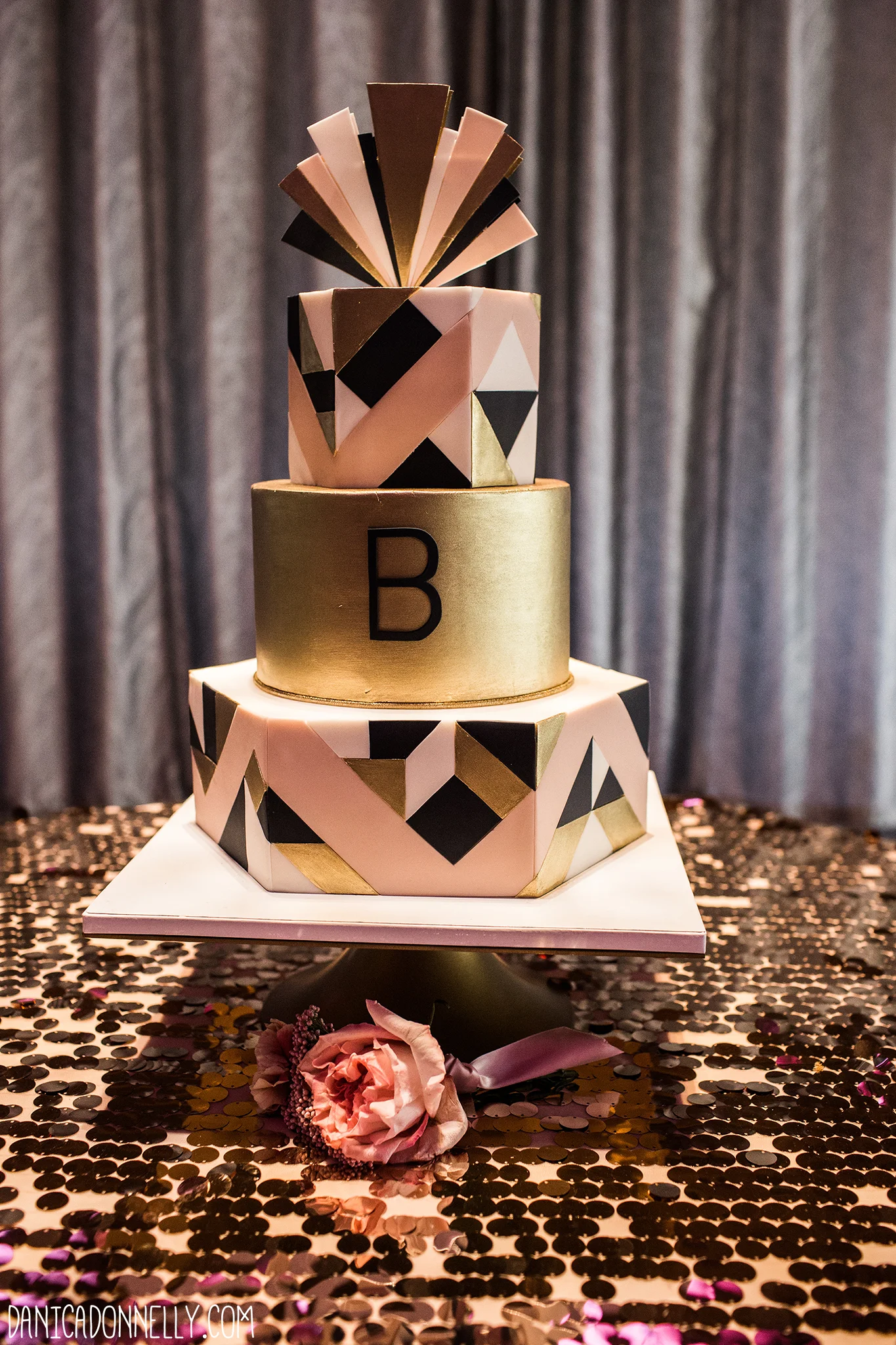This blush, gold, and navy wedding cake was designed for a couple whose wedding theme was inspired by Art Deco and The Great Gatsby. The intricate hand-cut geometric design is emphasized by the cake's hexagon-shaped tiers, which provide interesting angles and entice guests to walk around the cake to see them all! Captured by Danica Donnelly Photography