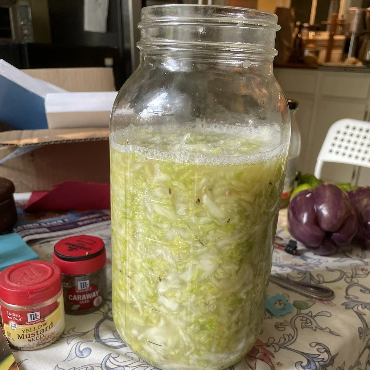 placed into a half gallon jar and pushed down below the liquid. no water added! that's all from salt and squeezing.