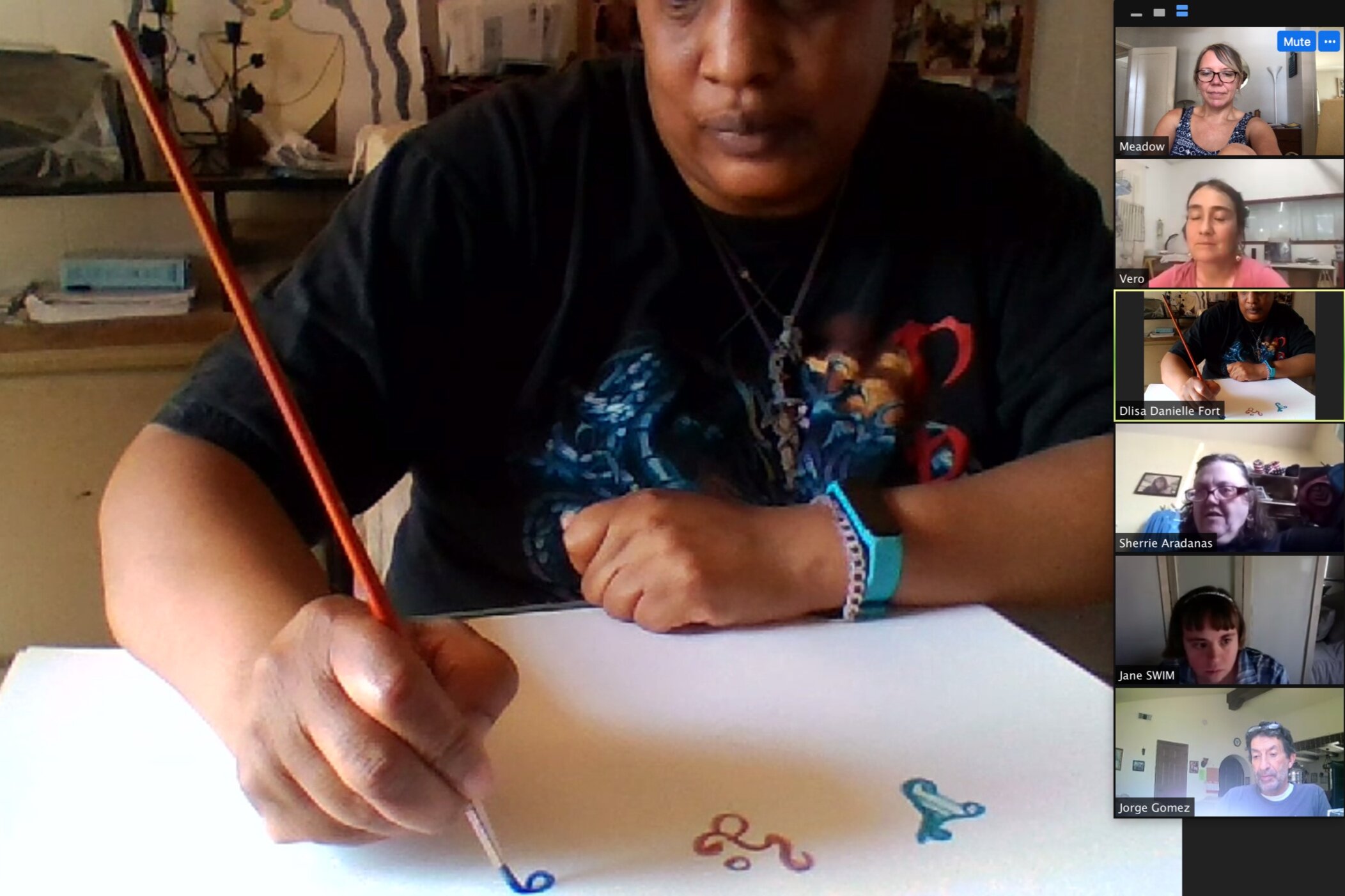 Artist D'Lisa Fort demonstrating how to paint symbols during her artist talk on mythology