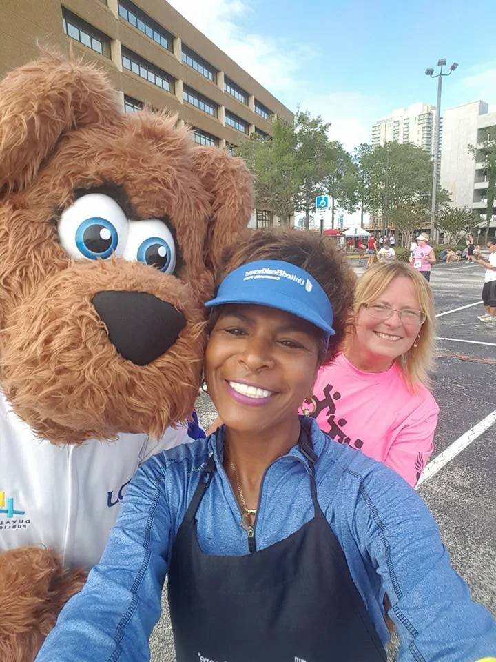 Sol Wynter with a Dog mascot and a woman wearing a pink shirt