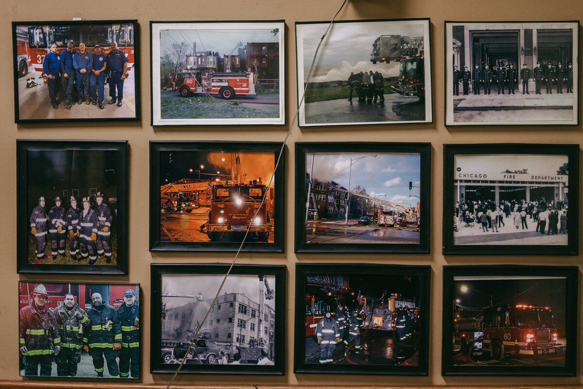  Photographs of current and former firefighters hang in the common area of the fire station. 
