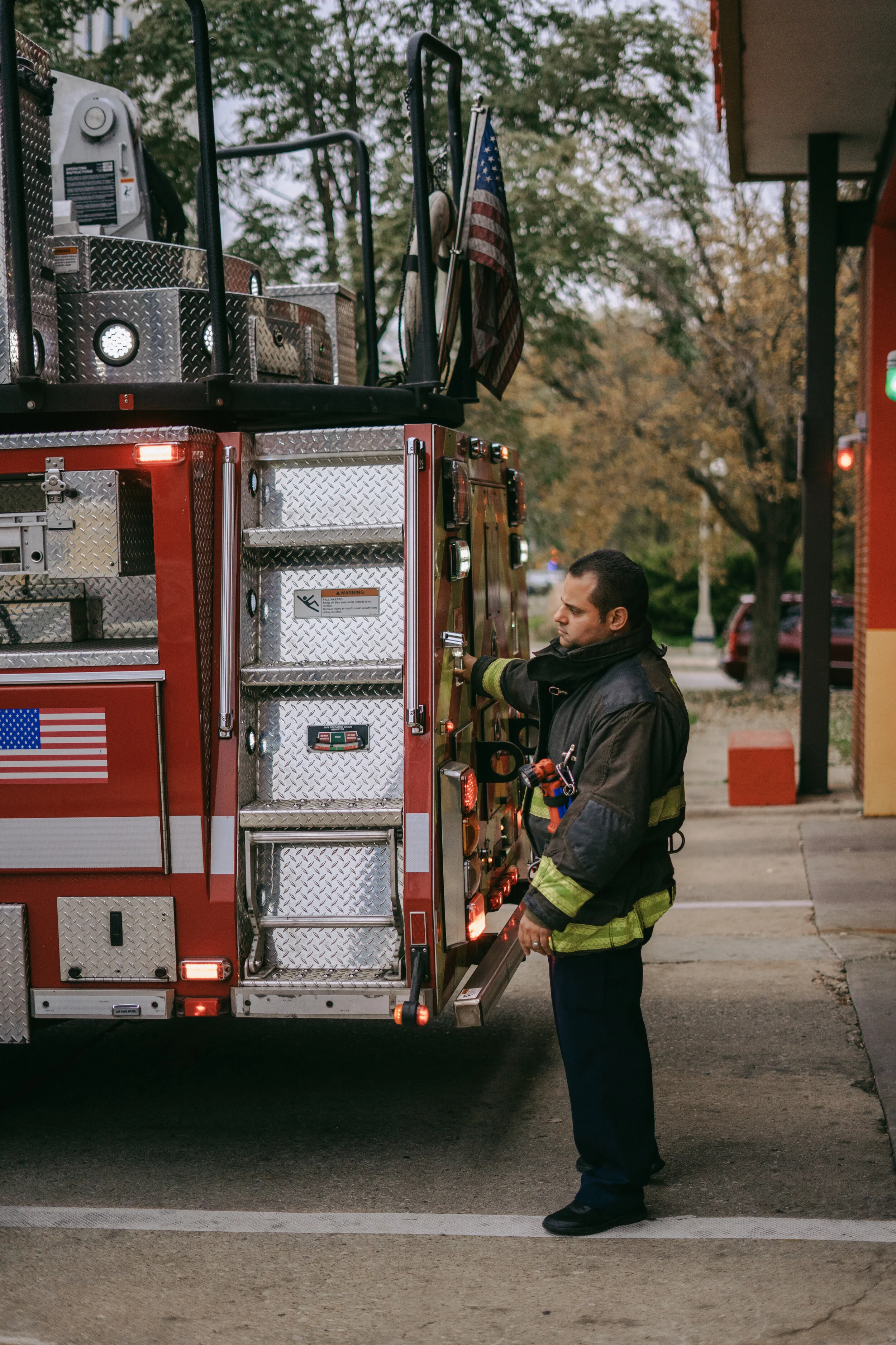  A firefighter inspects his truck. 