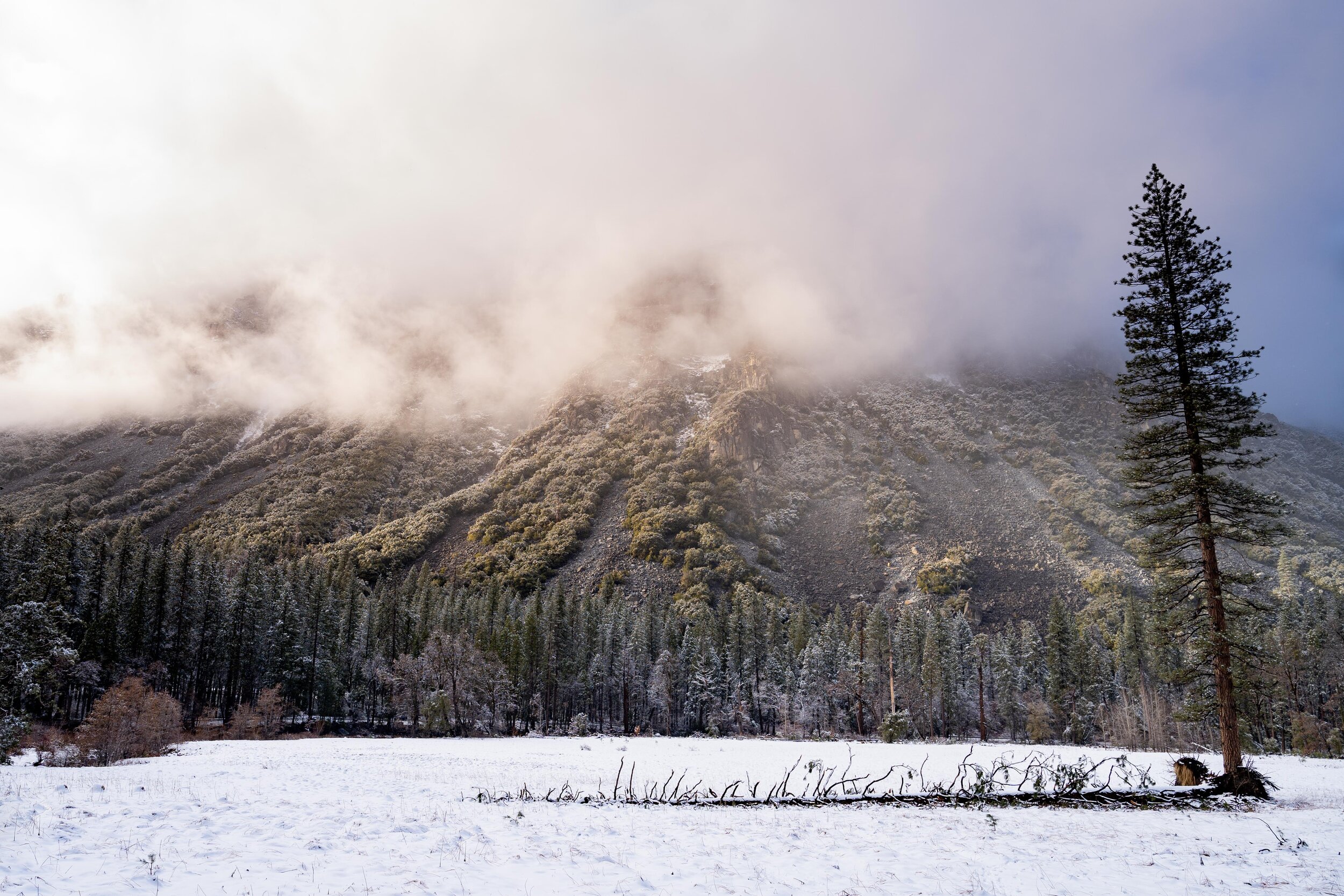 Sunset illuminates low-hanging clouds in Yosemite National Park.