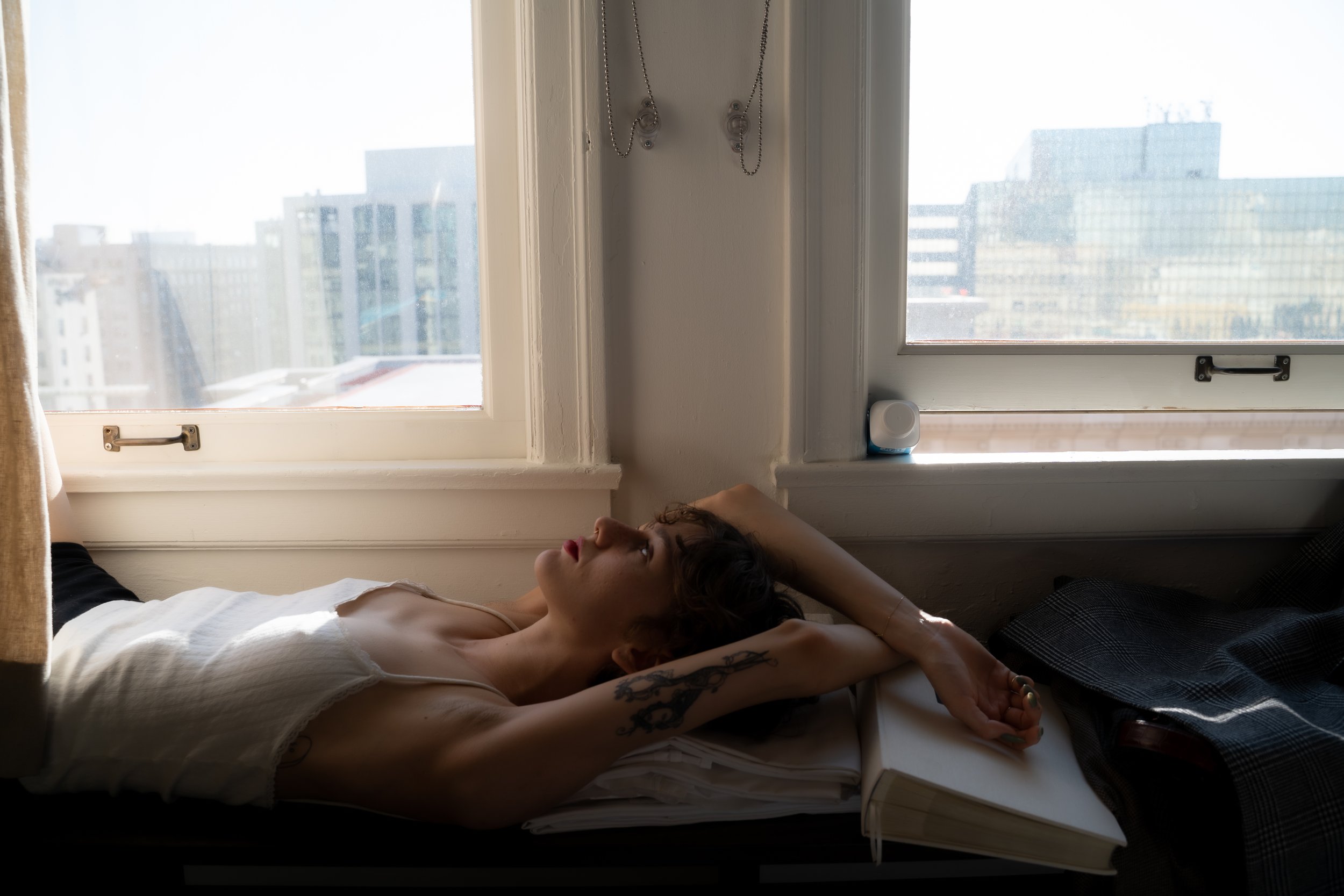 Belle Ives lays by the windowsill of their Ace Hotel room