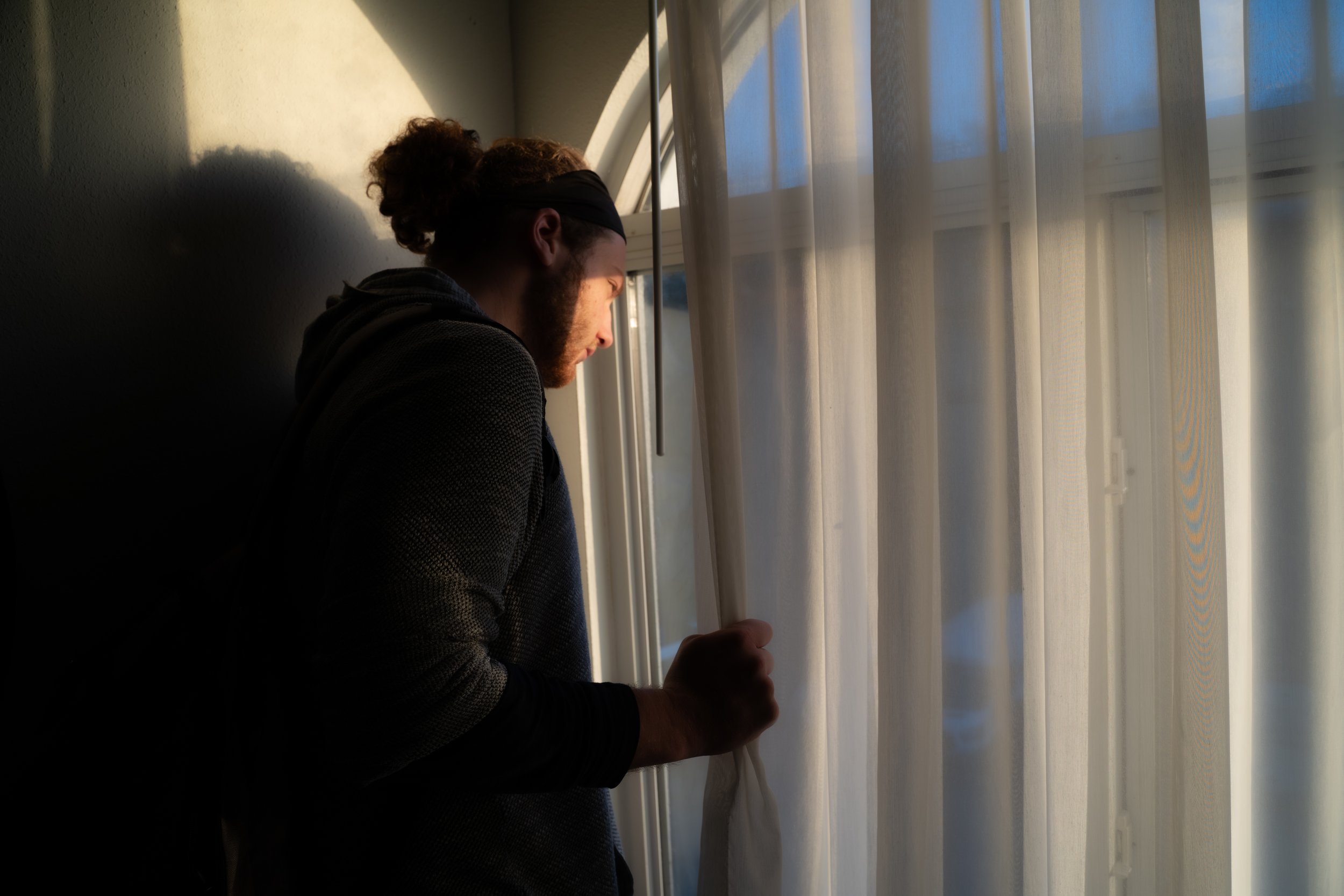 Ilan Lindenfeld looks out of a motel window