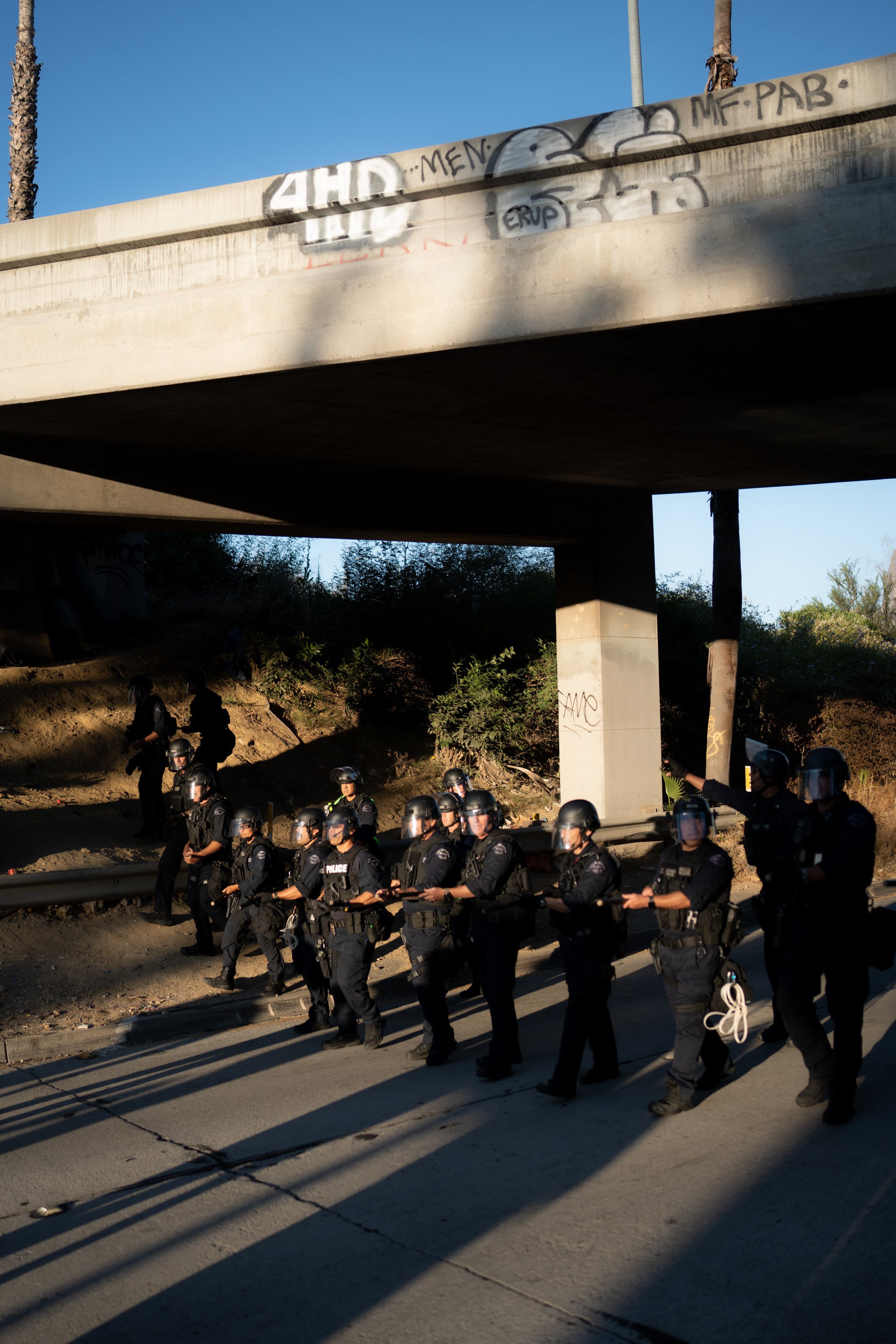 Police officers approach protesters on the freeway - June 24, 2022