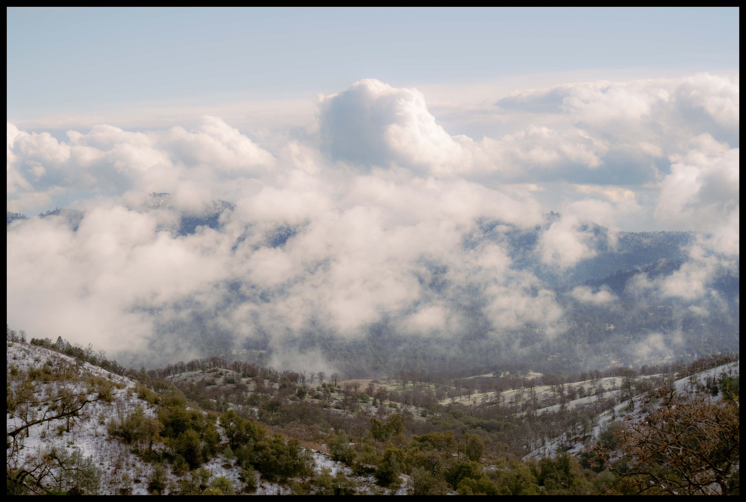 Clouds envelope a valley near Yosemite National Park.
