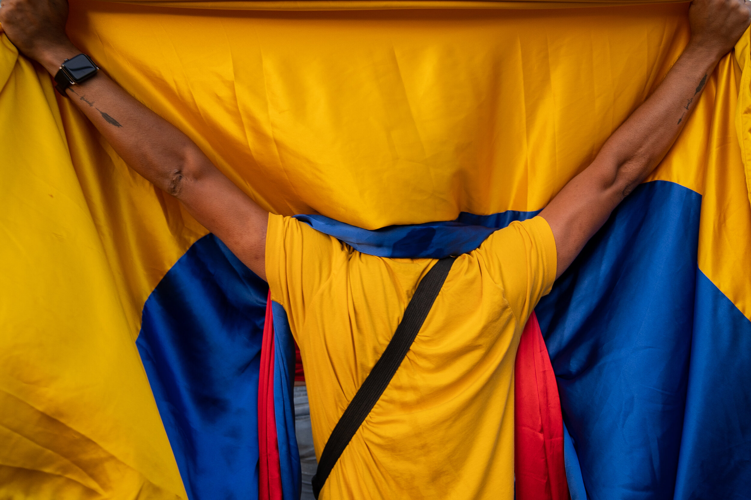 A man holds up a Colombian flag during a protest in Beverly Hills.