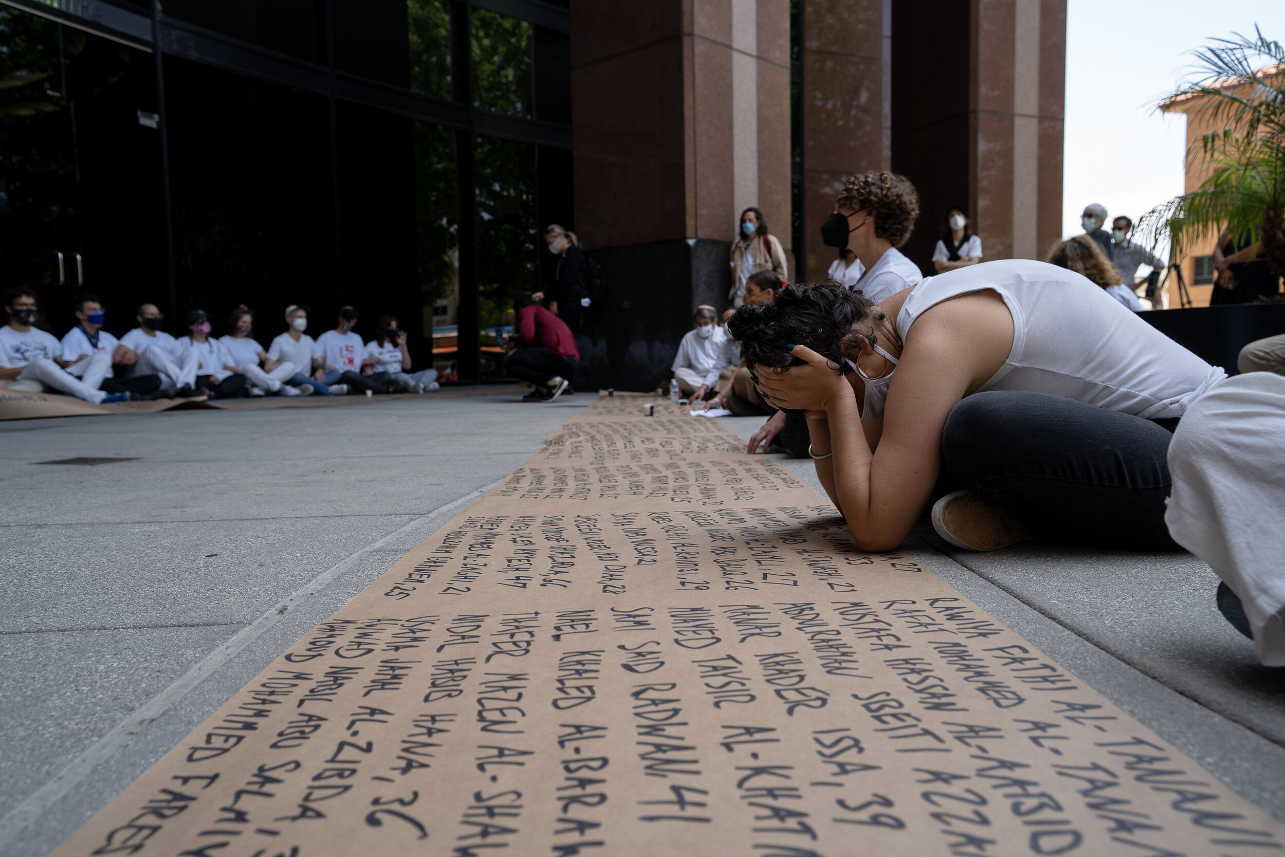 A protester holds her head in grief at an Anti-Zionist protest held by IfNotNow.