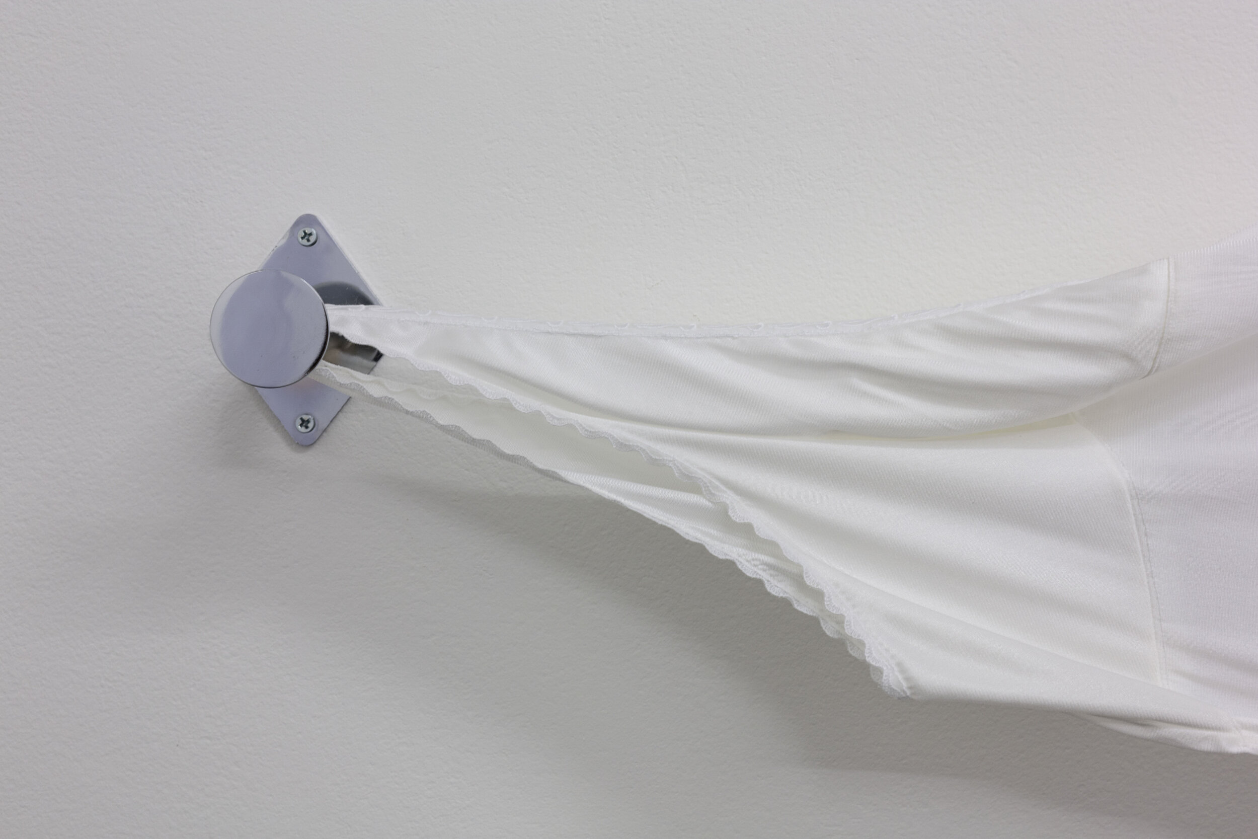 Lill Colgan,  Girl Introjected , 2020 various second-hand garments, nail polish, dressing room hooks and straight arm hanging rail, dimensions variable, installation view (detail),  A Hole Where There Once Was A Logo , 2020, Firstdraft, Sydney. Photo: Jessica Maurer. Courtesy the artist.