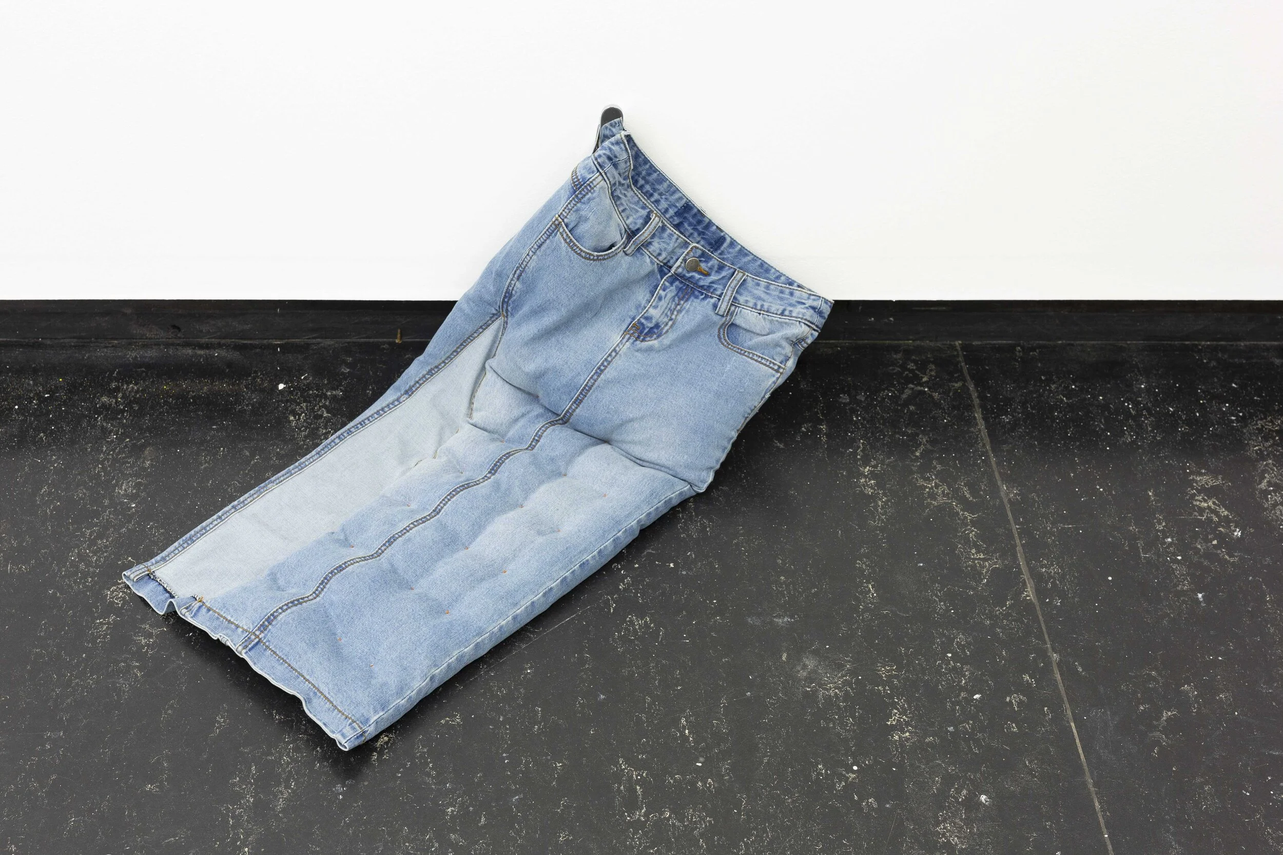 Lill Colgan,  Garment Must Be Handled Delicately, Pulled to Shape, Hand Squeezed , 2020, chrome nesting tables, dressing room hook, second-hand garments, rice, and essential oils dimensions variable,  A Hole Where There Once Was A Logo , 2020, installation view (detail), Firstdraft, Sydney. Photo: Jessica Maurer. Courtesy the artist.
