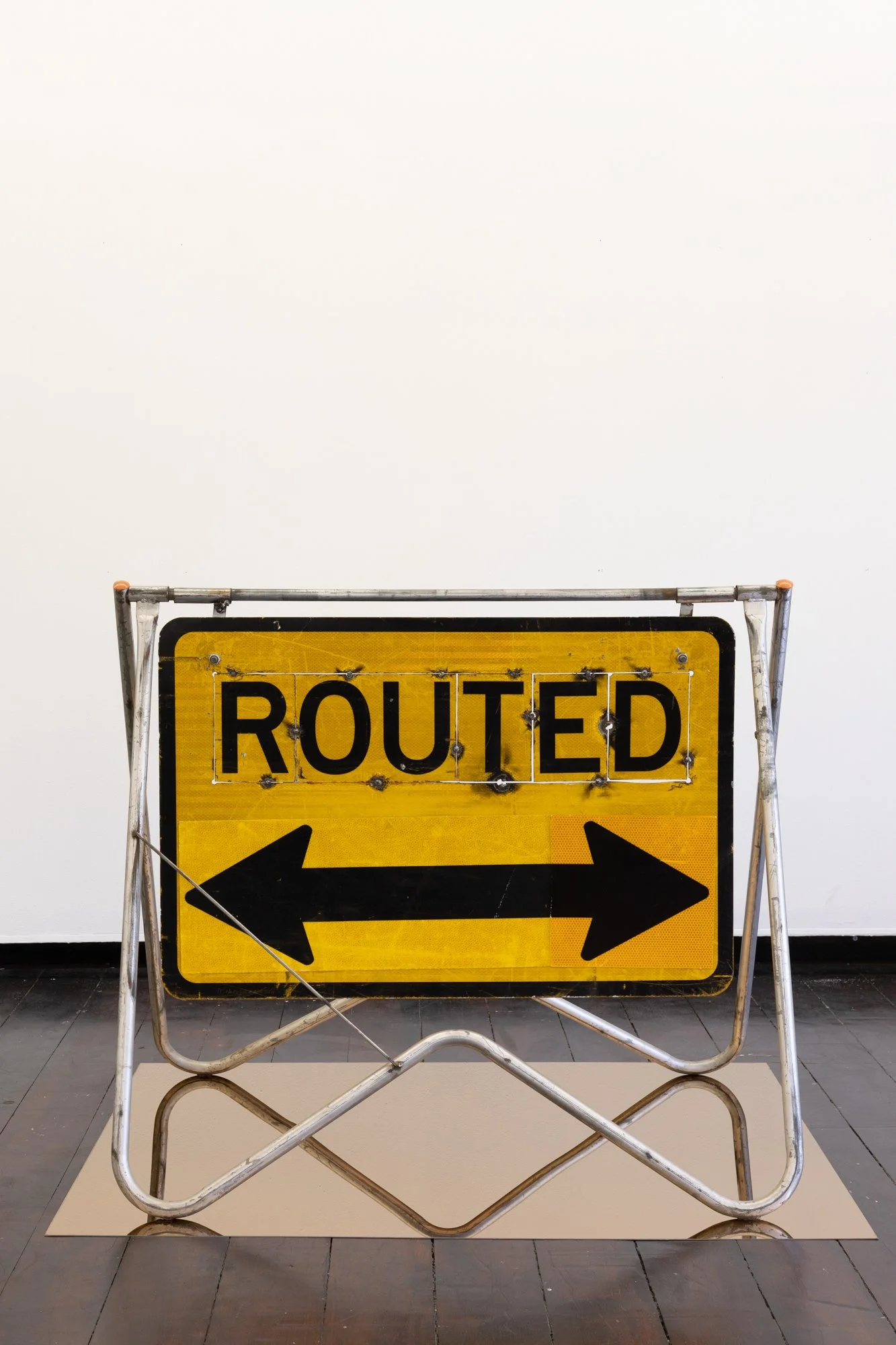 Zachariah Fenn, ROUTED/DETOUR, 2023, Mixed media on altered traffic sign, steel A-frame stainless steel, timber pallet, caster wheels, 150 x 120 x 90 cm