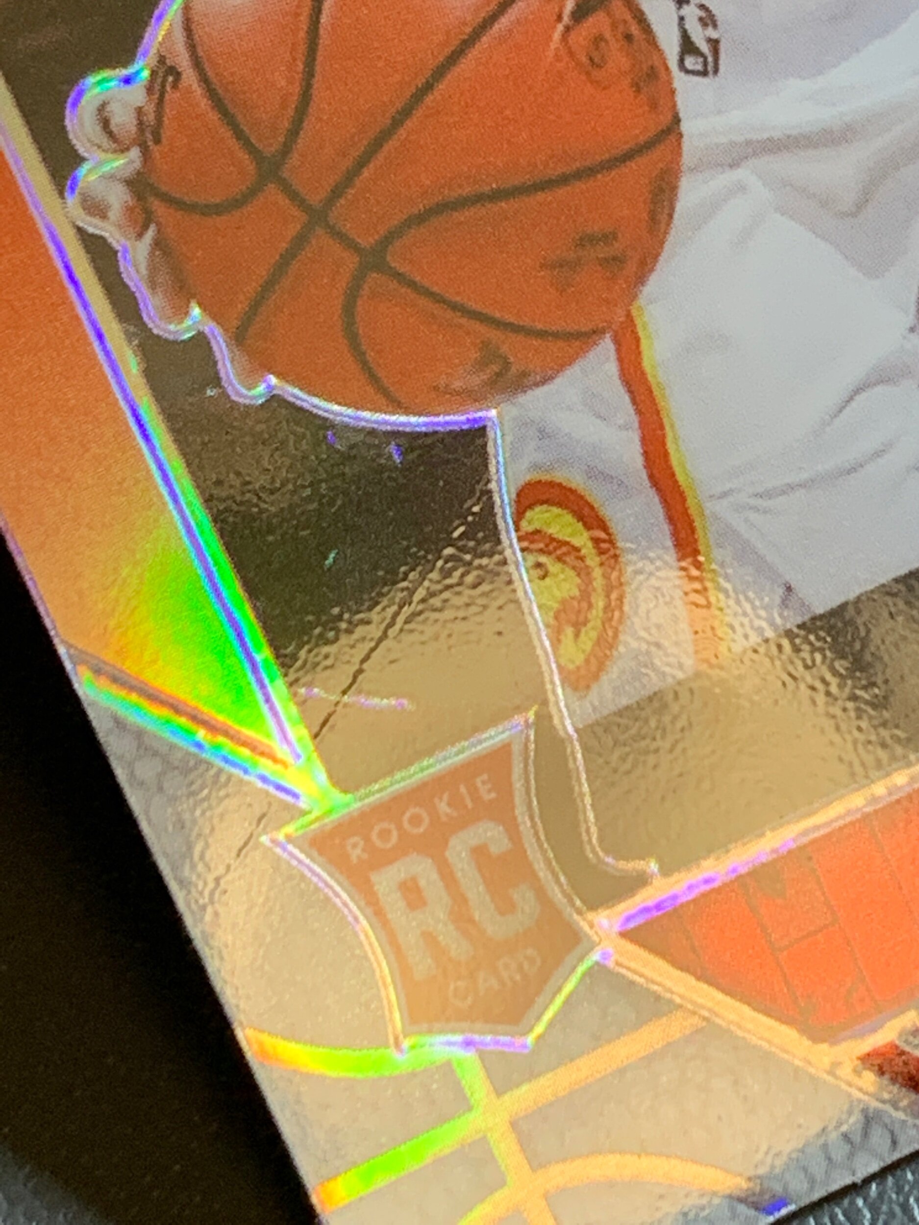 That’s a big scratch this 2019-20 NBA Hoops Premium Stock De’Andre Hunter Red Prizm RC is sporting.