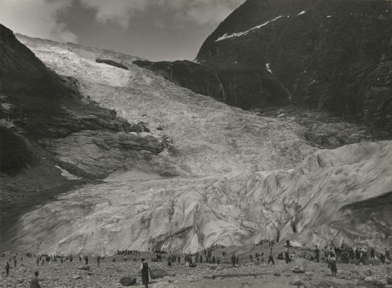 In 1935 reisden 565 jongens en hun begeleiders naar de Noorse fjorden op het "kampeerschip" de Tarakan. Hier staan ze onder aan de immense Boja Brae gletsjer. Noorwegen, Fjaerland, 1935. In 1953 565 boys and their guides made a trip on the ship the Tarakan to the Norwegian fjords. Here they are near the Boja Brae glacier. Norway, Fjaerland, 1935.