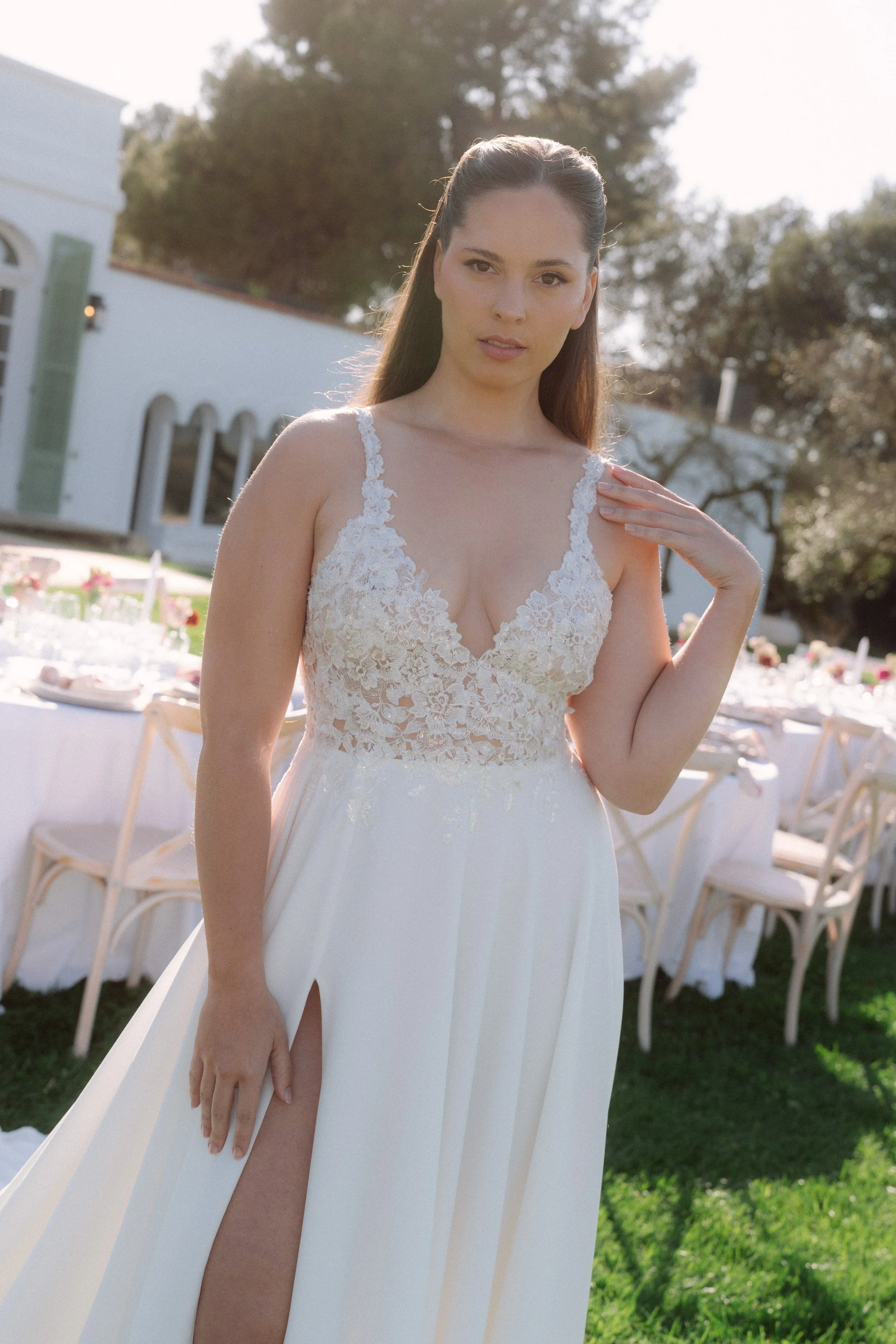 Mujer con vestido de novia en un evento al aire libre.