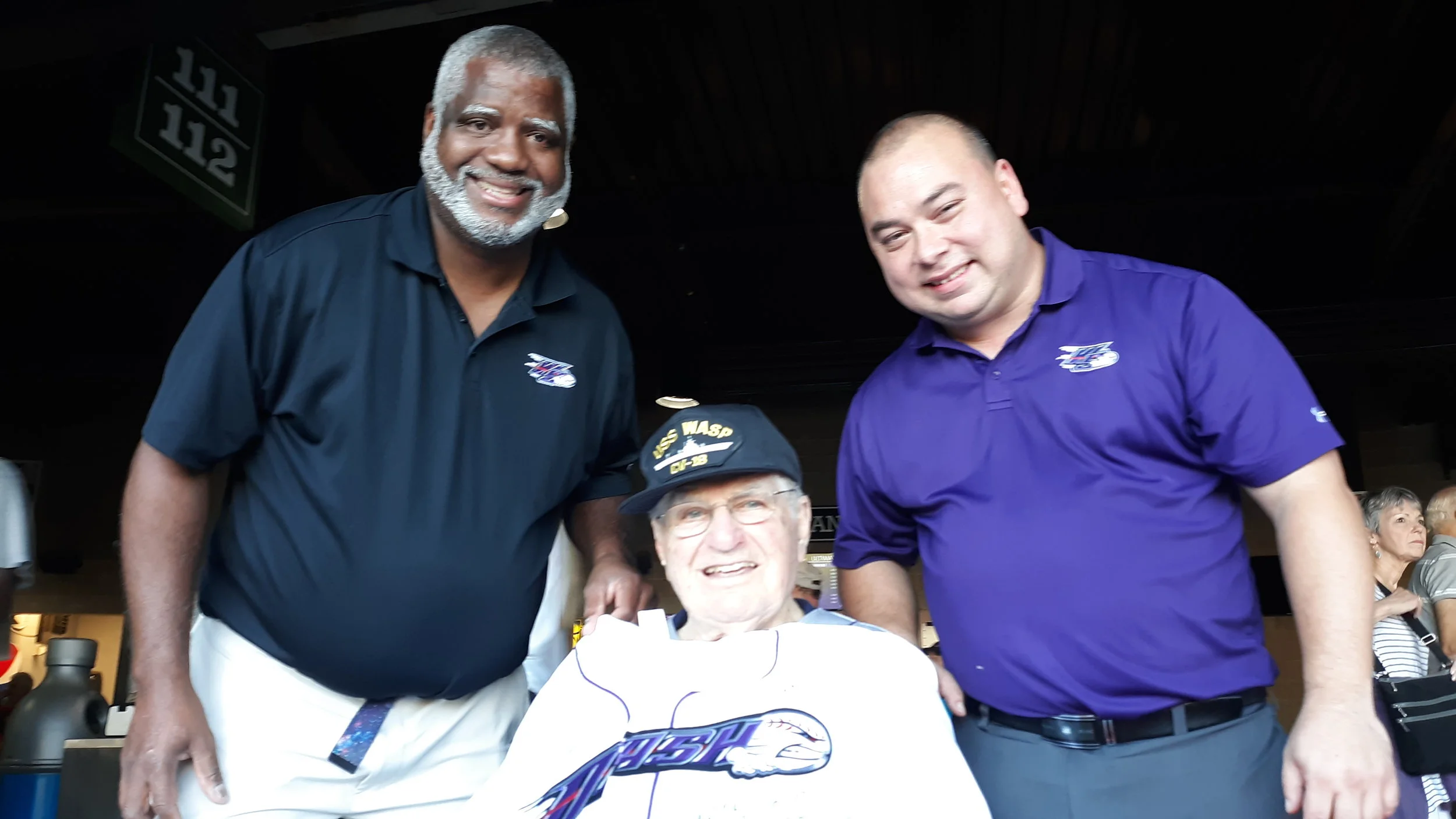 Dad’s 70 game streak is recognized with a team jersey, presented by Clubhouse Manager Marlon Quattlebaum (left) and ballpark manager Kit Edwards (right). What doesn’t show in the photo is that the jersey has been signed by all of the Winston-Salem Dash players.