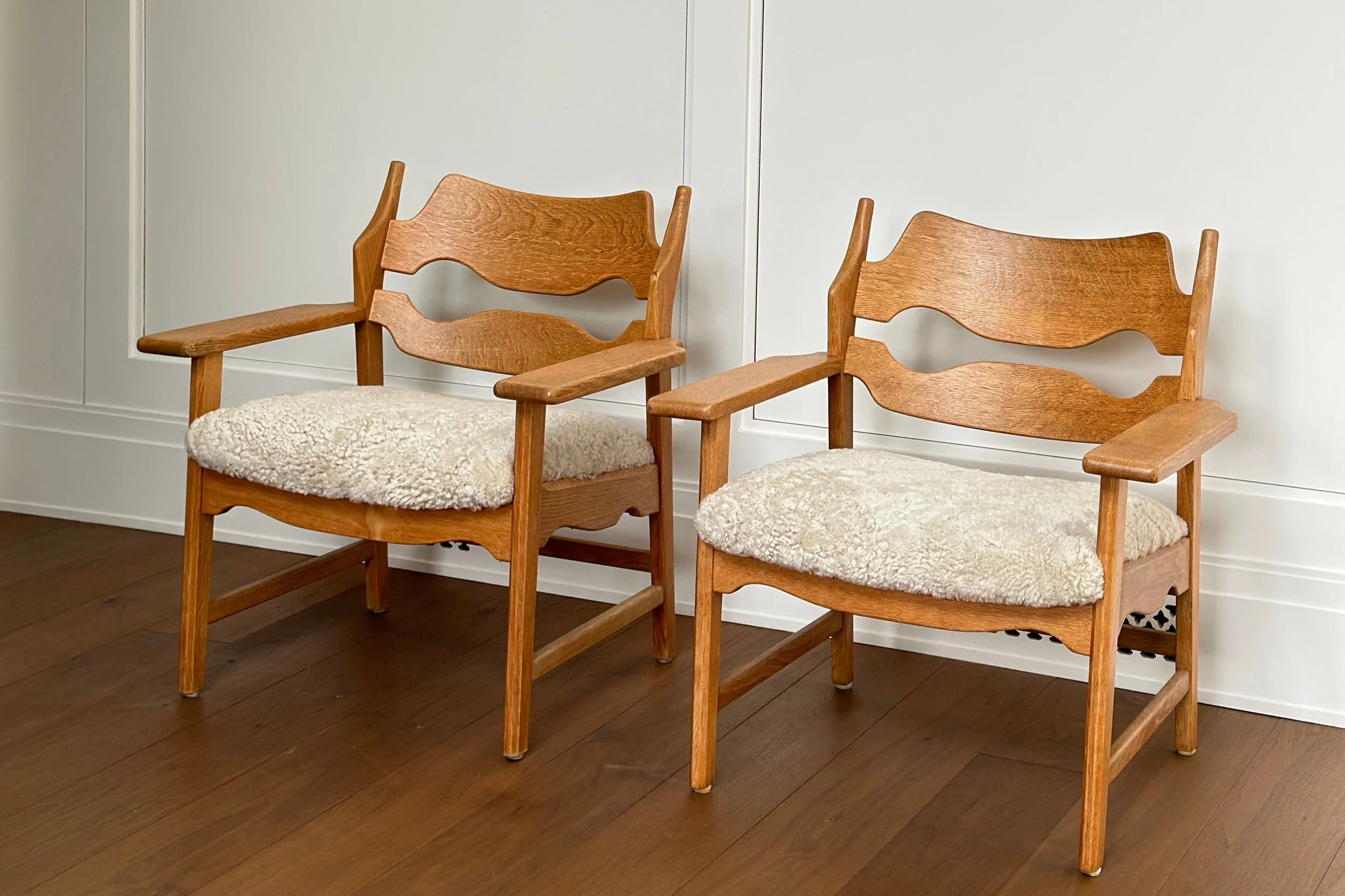 Pair of Oak and Shearling Chairs by Henning Kjærnulf, Denmark 1950s 30 1/2 (H) x 28 1/2 (W) x 26 (D) 16 inches (Seat Height)