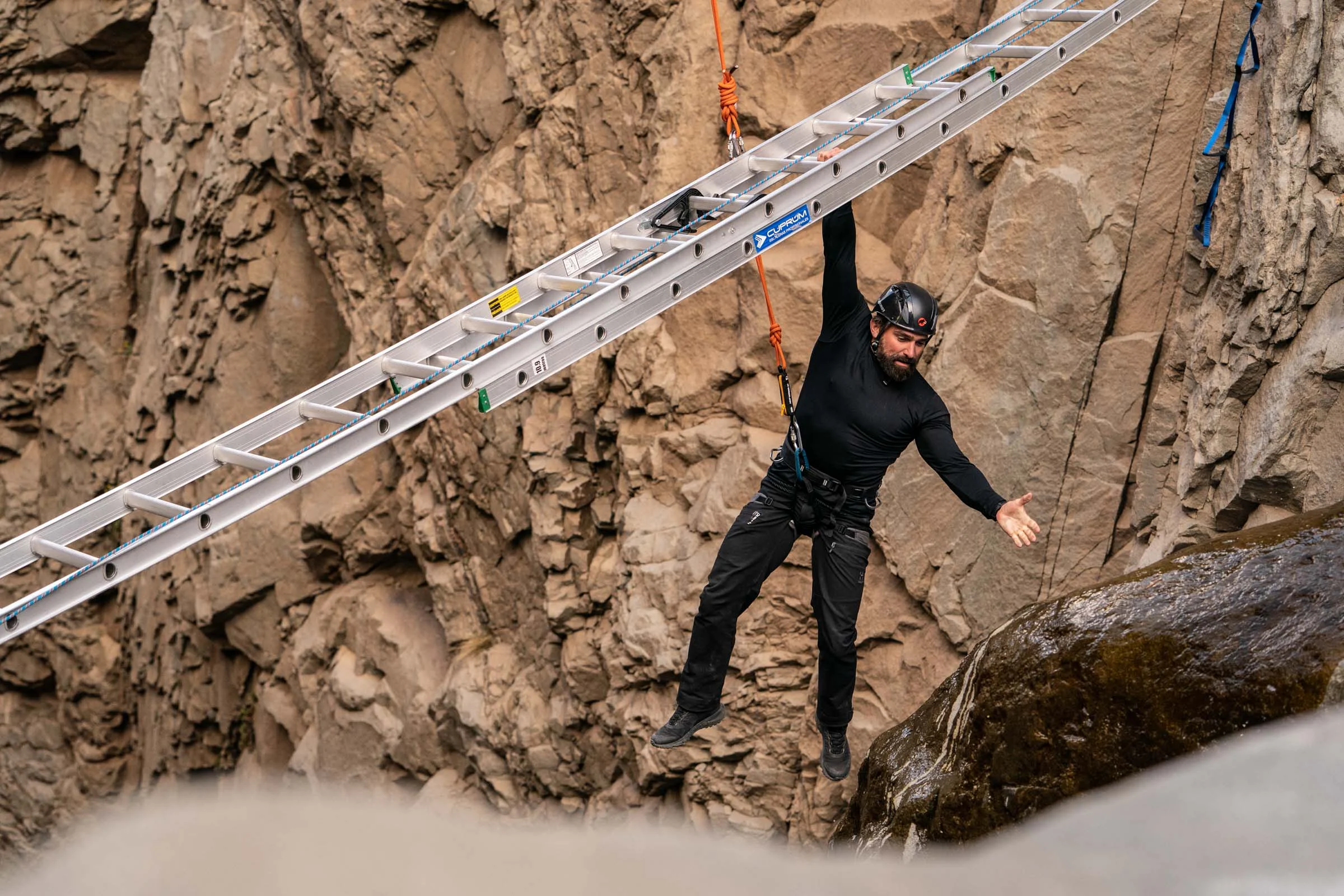 Chief Instructor Ant Middleton holds the ladder with one hand and stops to look down whilst crossing the Devils Throat Episode 4 Minnow Films / Channel 4
