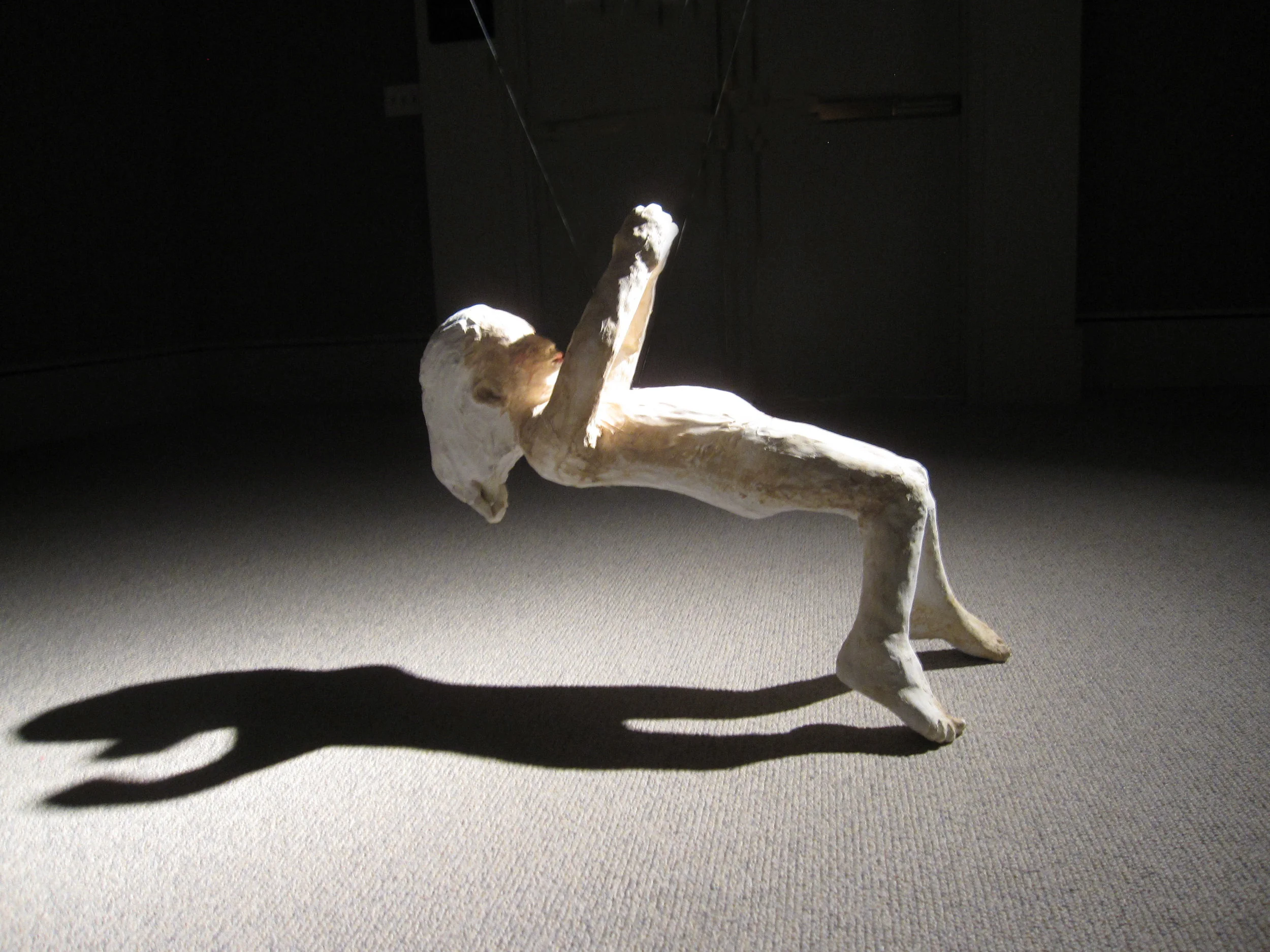 Falling (Girl on back), 2011, Painted ceramic, Installation view, Museum of Nebraska Art, Kearney, Nebraska