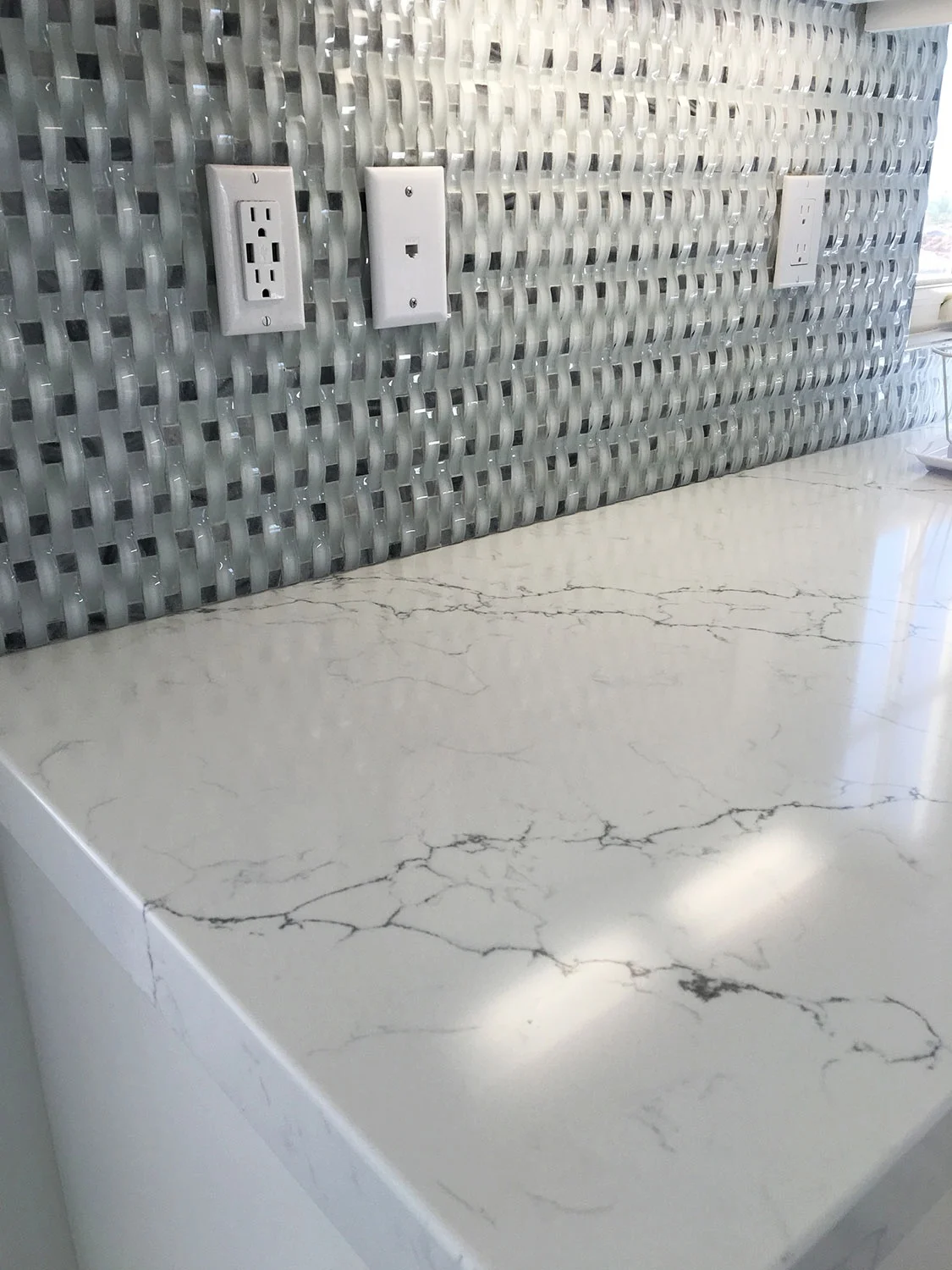 Quartz Countertop with Glass Mosaic Backsplash in Kitchen of House in San Clemente