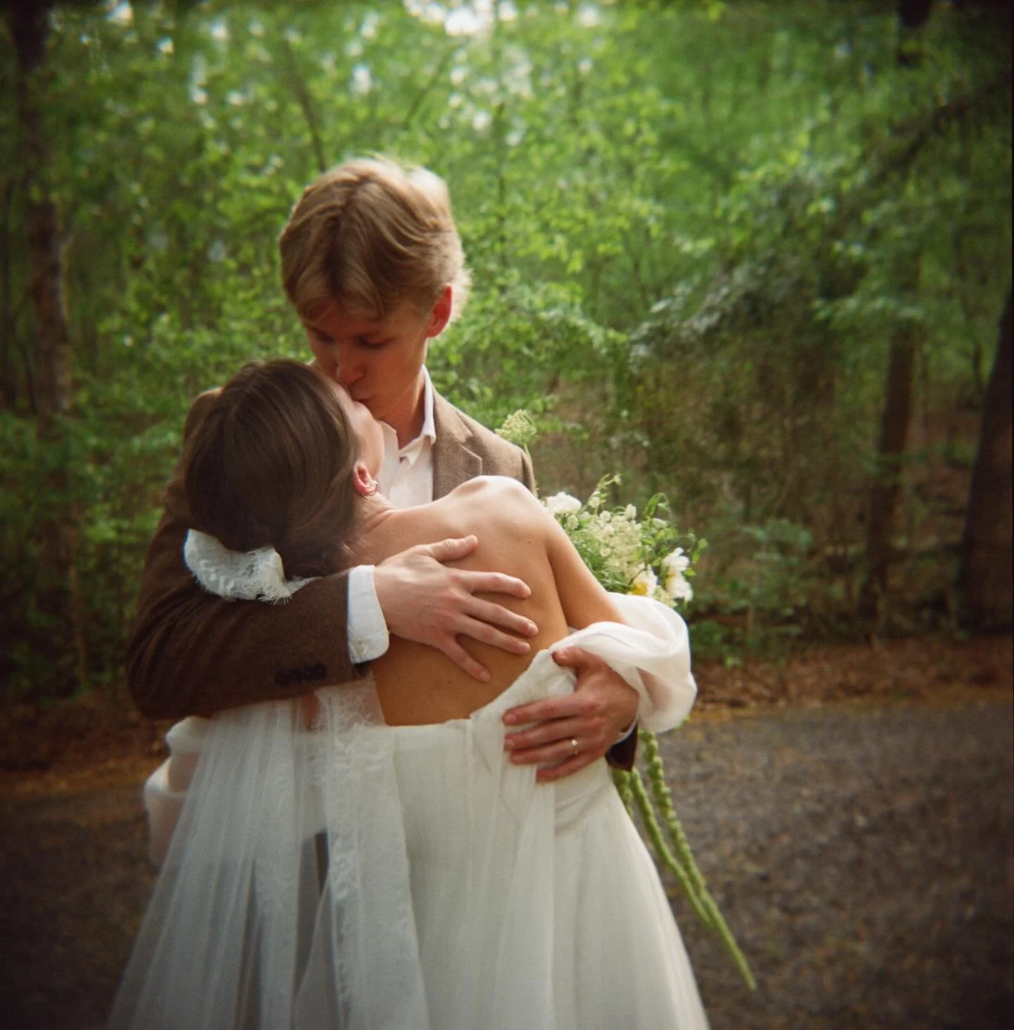 Married in the woods with the river rushing behind them. Then it started raining. Not a care in the world. These two are crazy about eachother and it&rsquo;s obvious.🩷