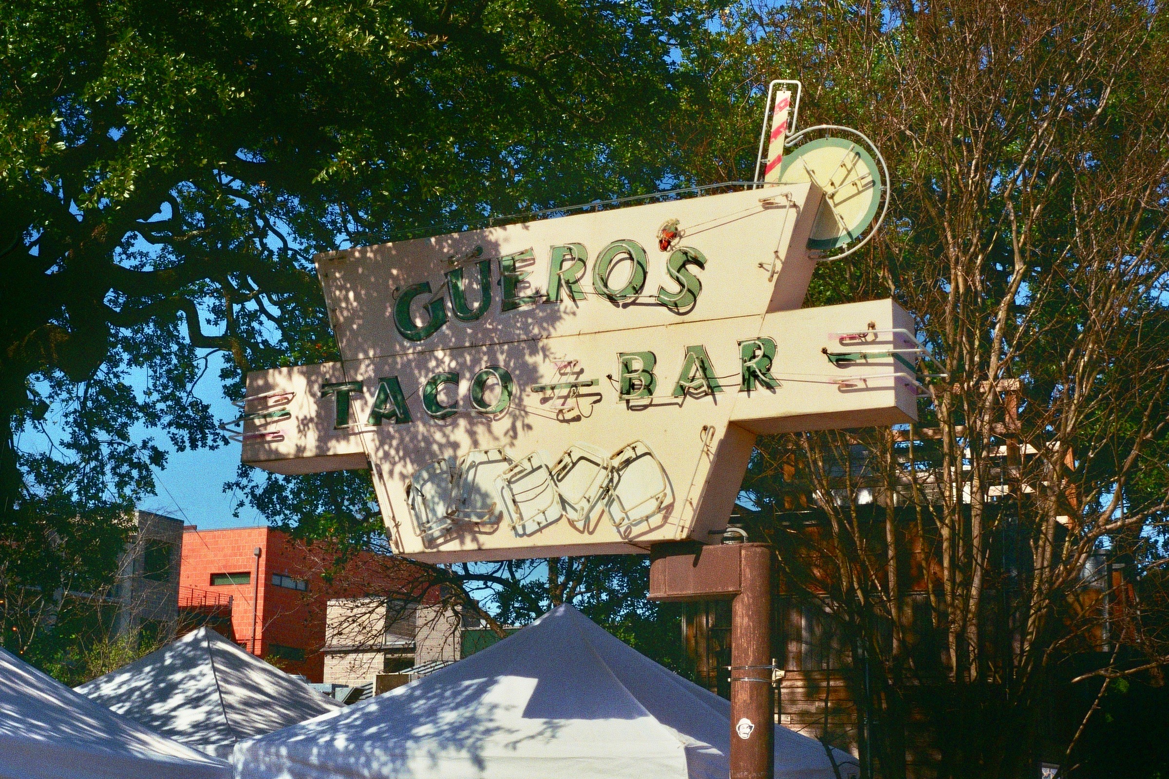 Old signs look down on new pop-up shops. South Congress, Austin, TX
