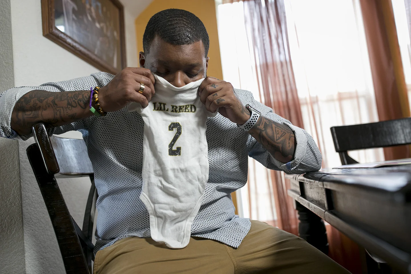 Jeronte Reed at his home in Killeen holding a onesie belonging to his son, Jaxson Partridge-Reed, who died at age 1 in an illegal day care in Killeen in 2017. Jaxson is one of nearly 90 children who have died as a result of abuse or neglect at a Tex…