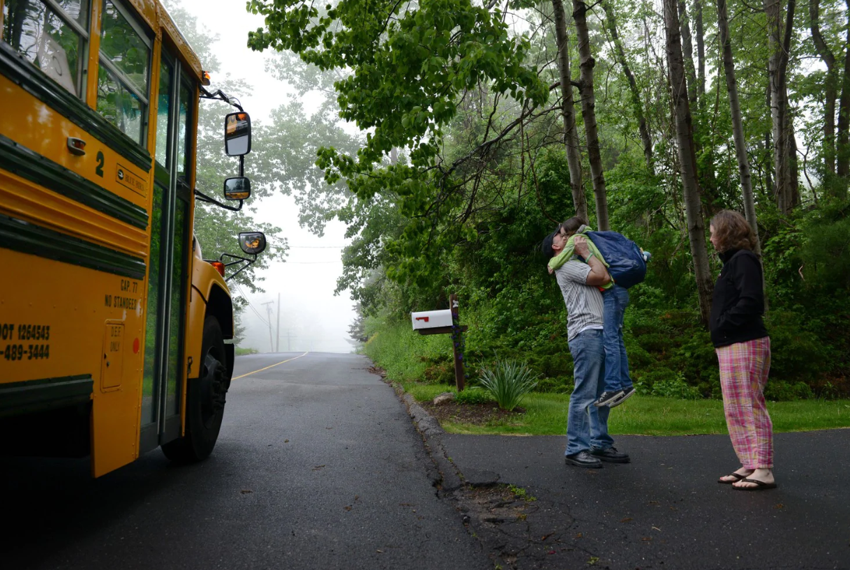 Mark and Jackie Barden hug their 11-year-old daughter, Natalie, before she goes to school in Newtown, Conn., in May. [Photo: Linda Davidson/The Washington Post]