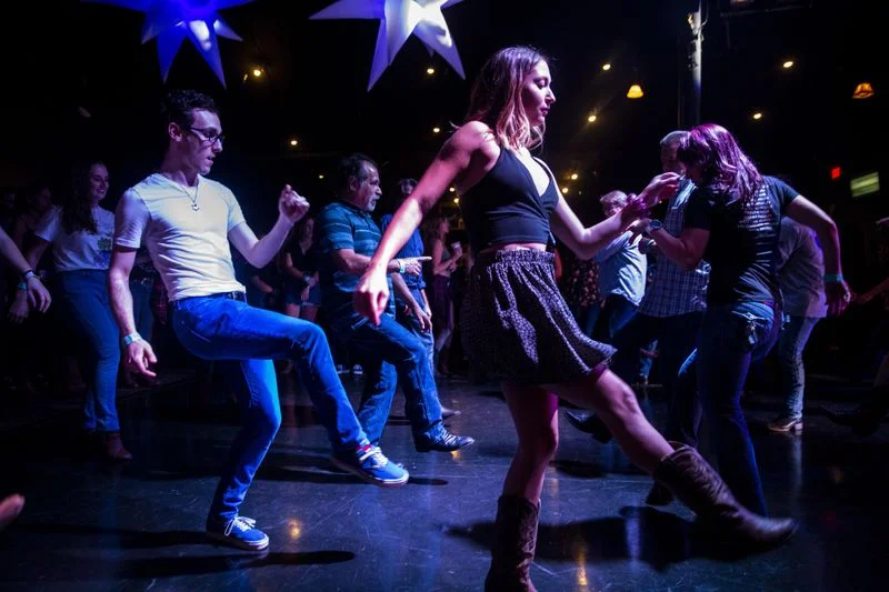 Ben Ginsburg, 23, of Woodland Hills and Kylie Rice, 19, of Simi Valley dance at Borderline Country Night at The Canyon bar. On Thursday, more than a thousand people — including many survivors — gathered for the first night of line dancing since the …