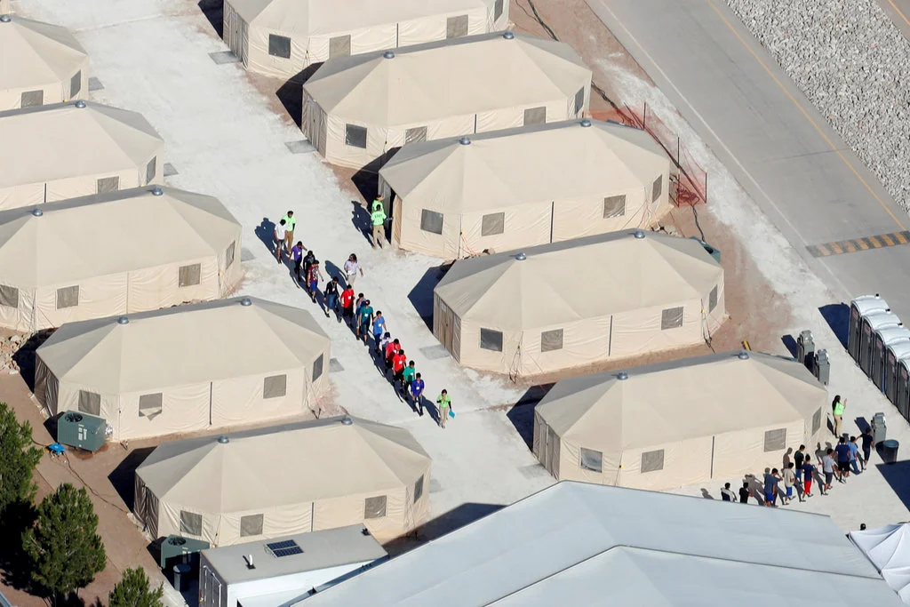 Migrant children, most from Central America, have been housed in a tent city in Tornillo, Tex., near the Mexican border. The facility, which opened in June, is preparing to close next month. [Photo: Mike Blake /  Reuters]