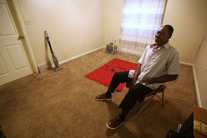 Theodore Thompson sits Friday in the empty North Little Rock apartment he moved into recently. Thompson is caught in a series of legal and emotional battles with his former landlord, Imran Bohra, who Thompson says seized his belongings in an evictio…