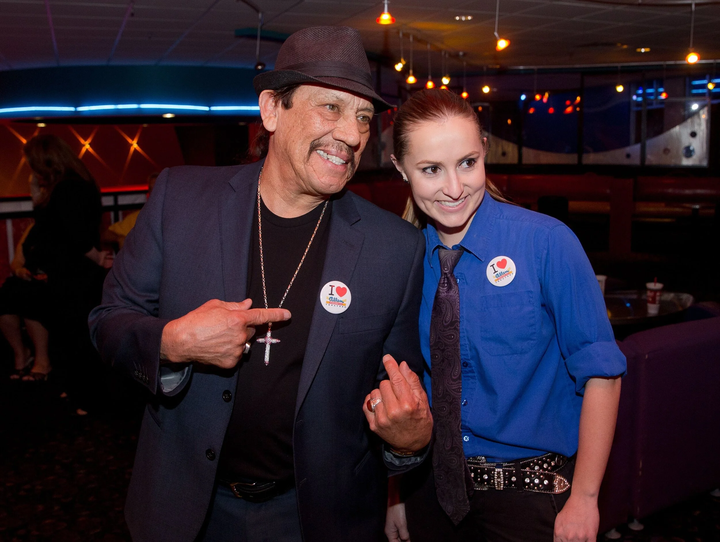 Actor Danny Trejo poses while wearing an “I Love Allen Theatres” button with Allen manager Erin Whitehead at the Cineport 10 Theatre during the Las Cruces International Film Festival on March 3, 2016. Trejo attended the festival as the “Outstanding …
