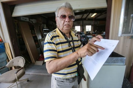 Eddie Bernal, 81, was diagnosed with COVID-19 and admitted to the hospital for 17 days. The virus affected his memory, he said. Here, Bernal shows his discharge papers while at his home in Las Cruces on Saturday, May 30, 2020, after he was released …