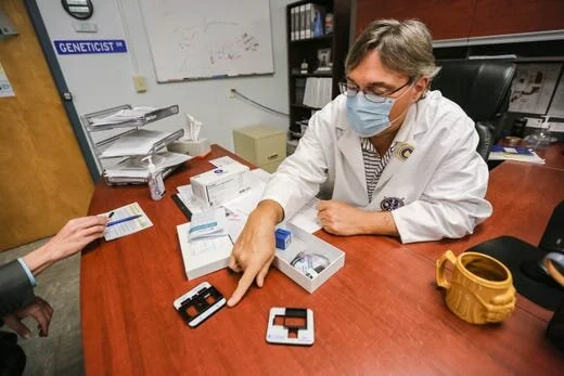 Stefan Long, the chief operating officer of Vanguard Genetics and Alliance DNA Laboratory, shows a portable testing kit that tests for COVID-19 antibodies in his laboratory on the campus of New Mexico State University in Las Cruces on Friday, June 1…