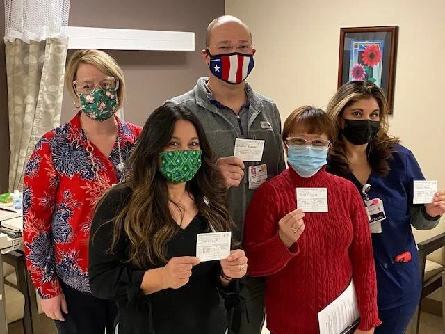 From left: Julie Reyes, R.N., who administered COVID-19 vaccines to MountainView Regional Medical Center employees, Ruth Villegas, R.N., Kristopher Crawford, M.D., Rosula Karaan, R.N., and Monica Prangner, R.N., display their COVID-19 vaccination ca…