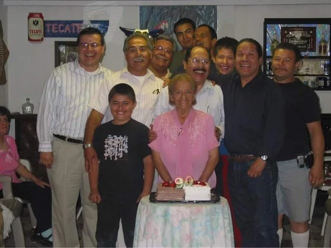 Sergio Vasquez, center, stands behind his mother, Pilar, during her 90th birthday celebration in this undated family photo. [Courtesy Photo / Gabe Vasquez]