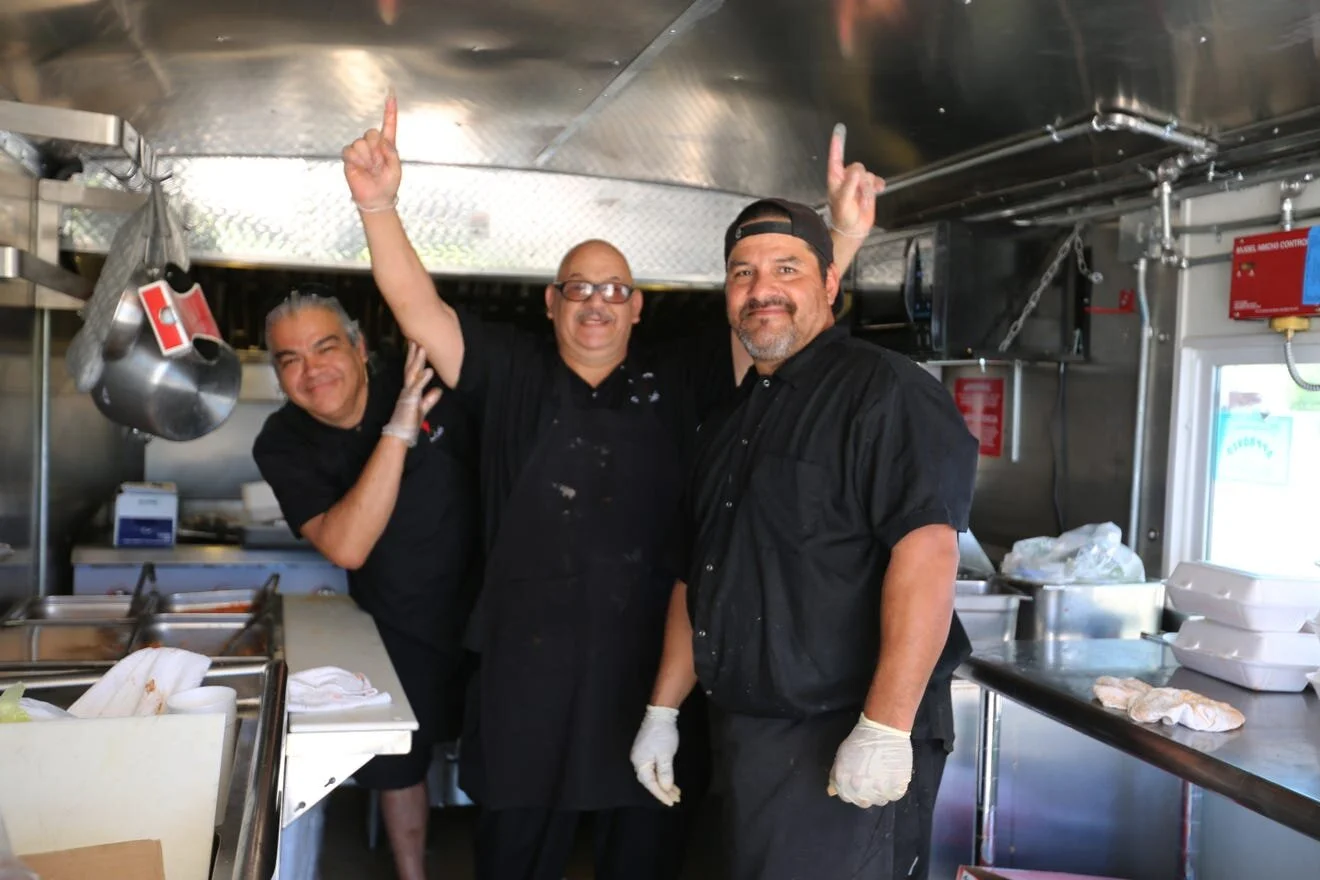 Cooks at La Nueva Casita Café, at 195 N. Mesquite St. in Las Cruces, serve the community free enchilada plates from the restaurant's food truck, Tuesday, April 28, 2020. The three agreed that they were doing this as a service to God. [Bethany Freude…
