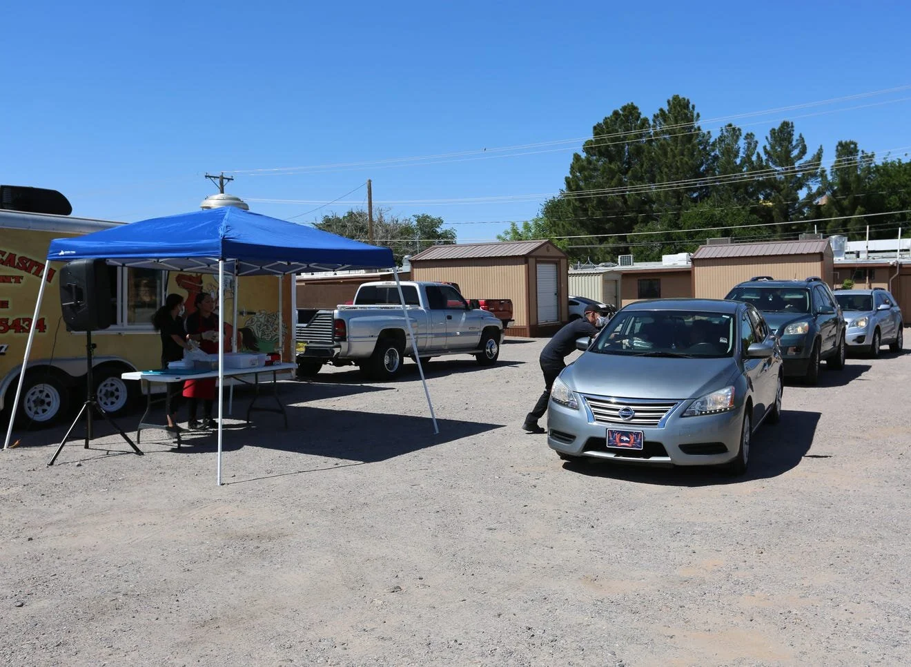 Just before noon, a line formed behind La Nueva Casita Café, at 195 N. Mesquite St. in Las Cruces, as residents wait for free enchilada plates. [Bethany Freudenthal / Las Cruces Sun-News]