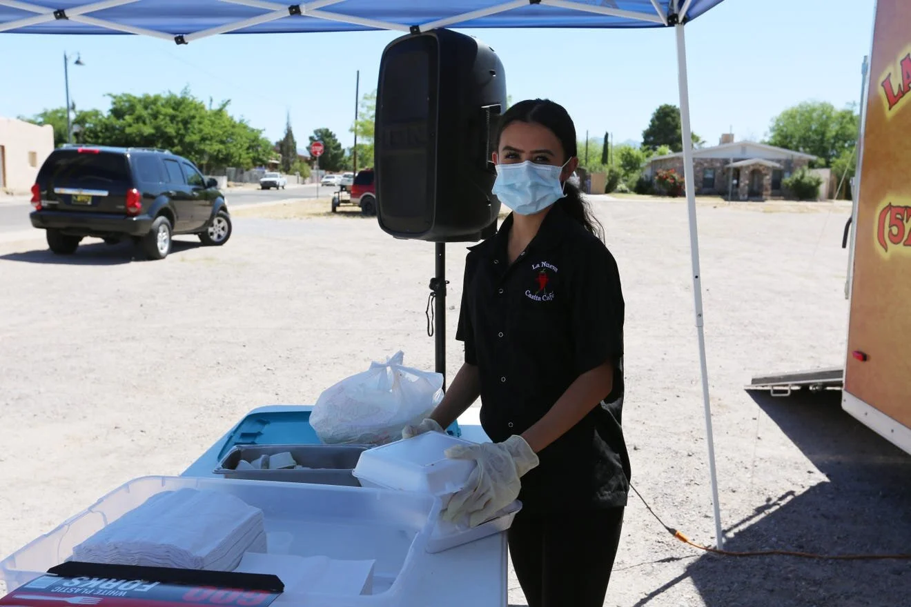 Leslie Paredes helps serve the community free enchilada plates at La Nueva Casita Café on Tuesday, April 28, 2020. [Bethany Freudenthal / Las Cruces Sun-News]