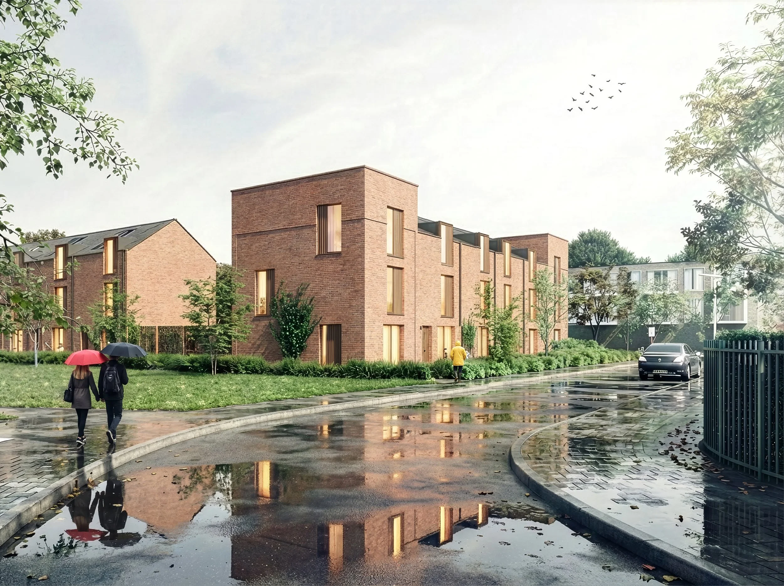 A modern residential area on a rainy day with puddles on the street, brick apartment buildings, green trees, and people walking with umbrellas.