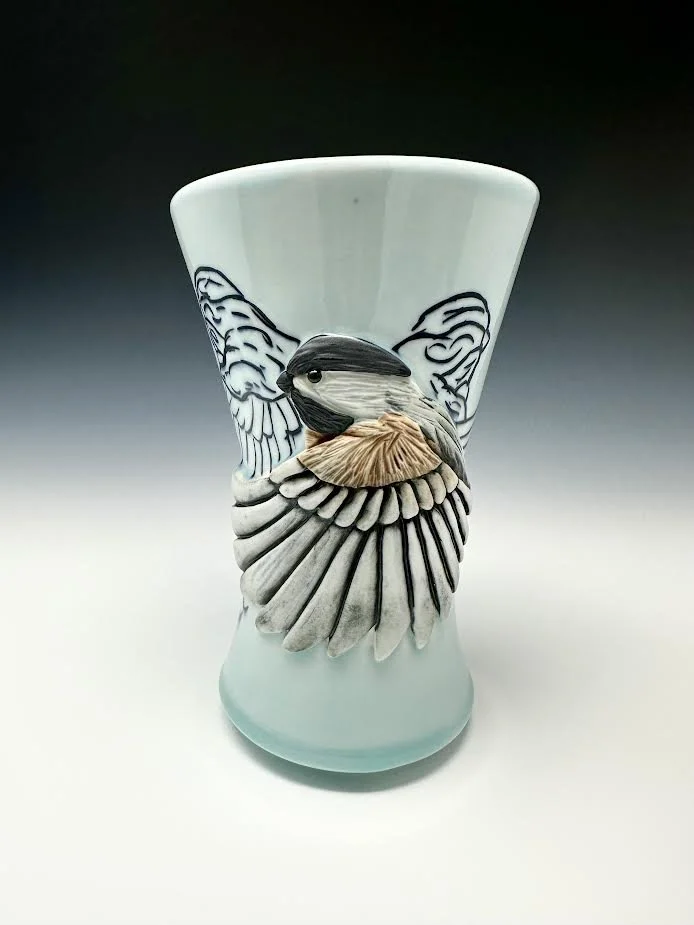 Chickadee with line carvings flying