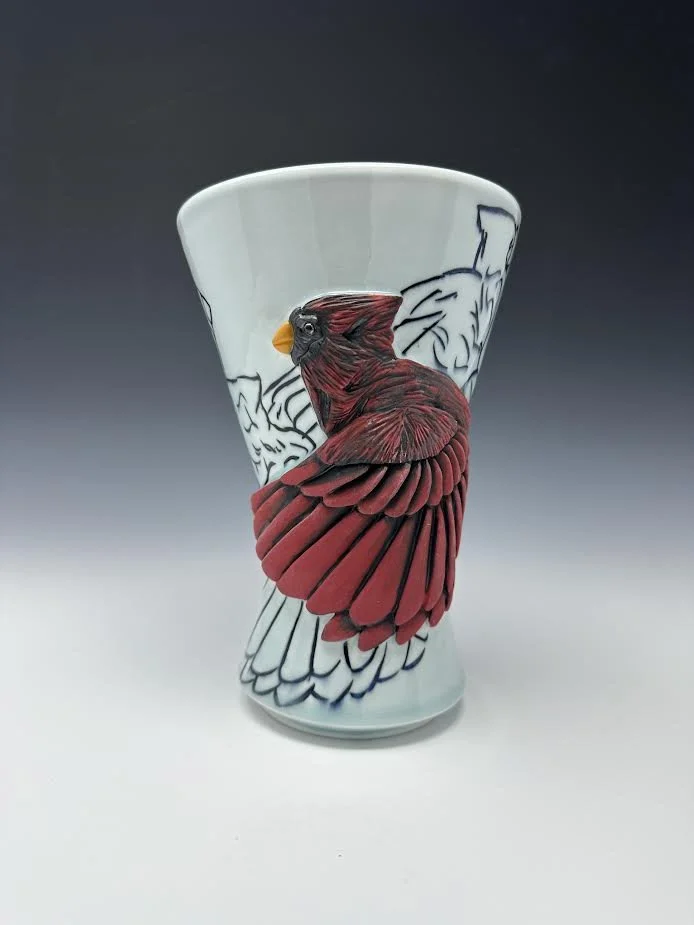 Cardinal with line carvings flying