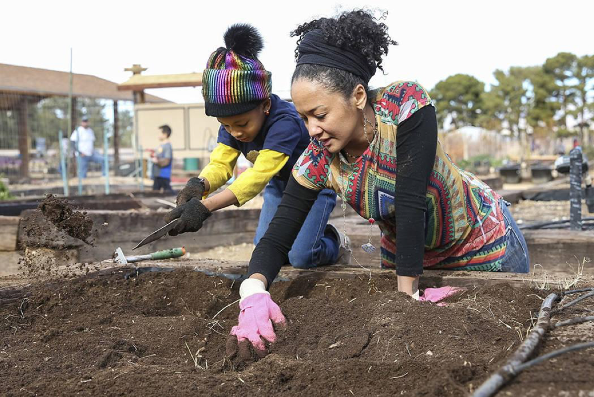 Volunteers Essence Hornick, 7, and her mother, Portia, stir up soil in a garden bed in preparation for early spring planting during a volunteering event at the San Miguel Community Garden located at 3939 Bradley Road in Las Vegas on Saturday, Jan. 12, 2019. Richard Brian Las Vegas Review-Journal @vegasphotograph
