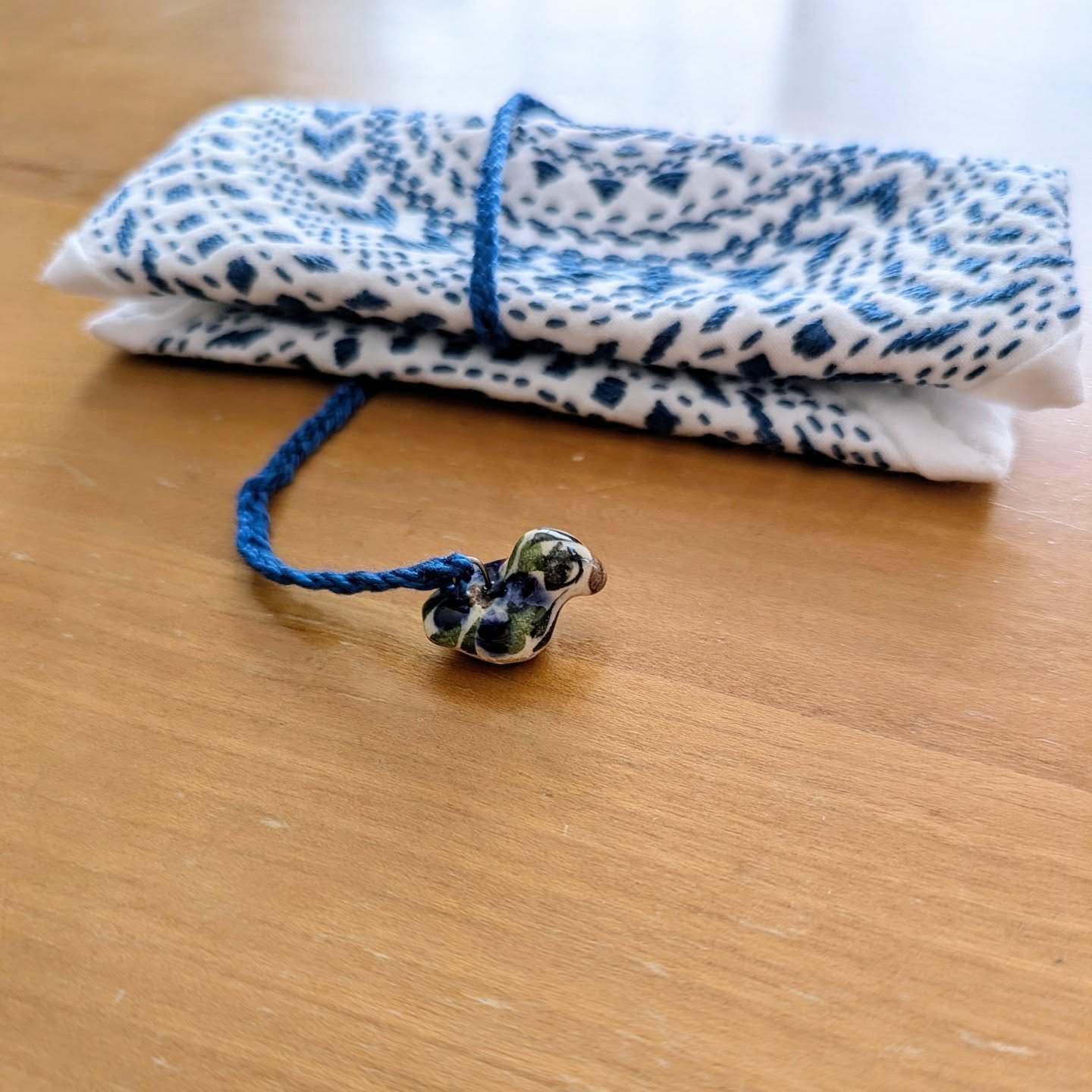 The tiny ceramic bird.
A symbol of connection to the spiritual realm. 
Messenger of peace.
Protector of hope.