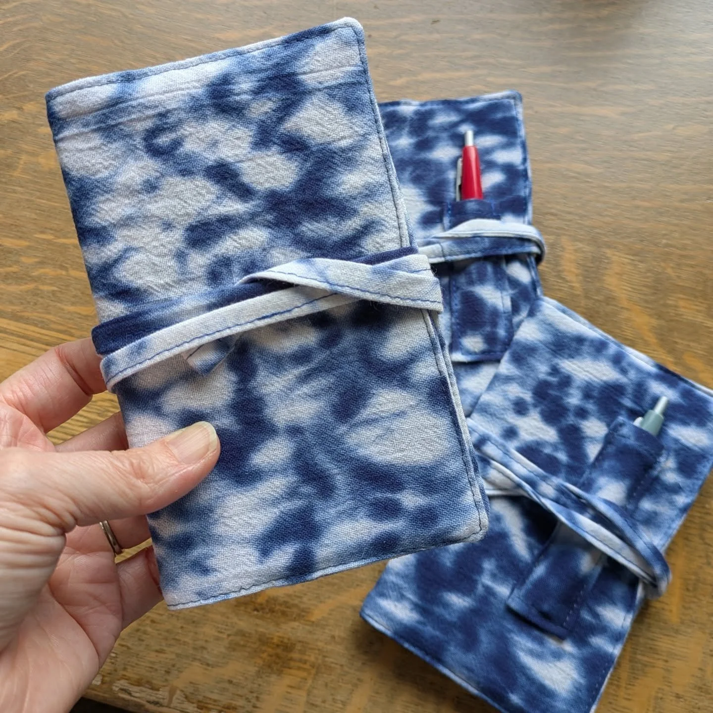 Does anyone still use paper notebooks to write things down? Well, if they do they should probably have a cute cover for their notebook. These are made from some of the fabric I tie-dyed in August. One doesn't have the little pen pocket ... because I 