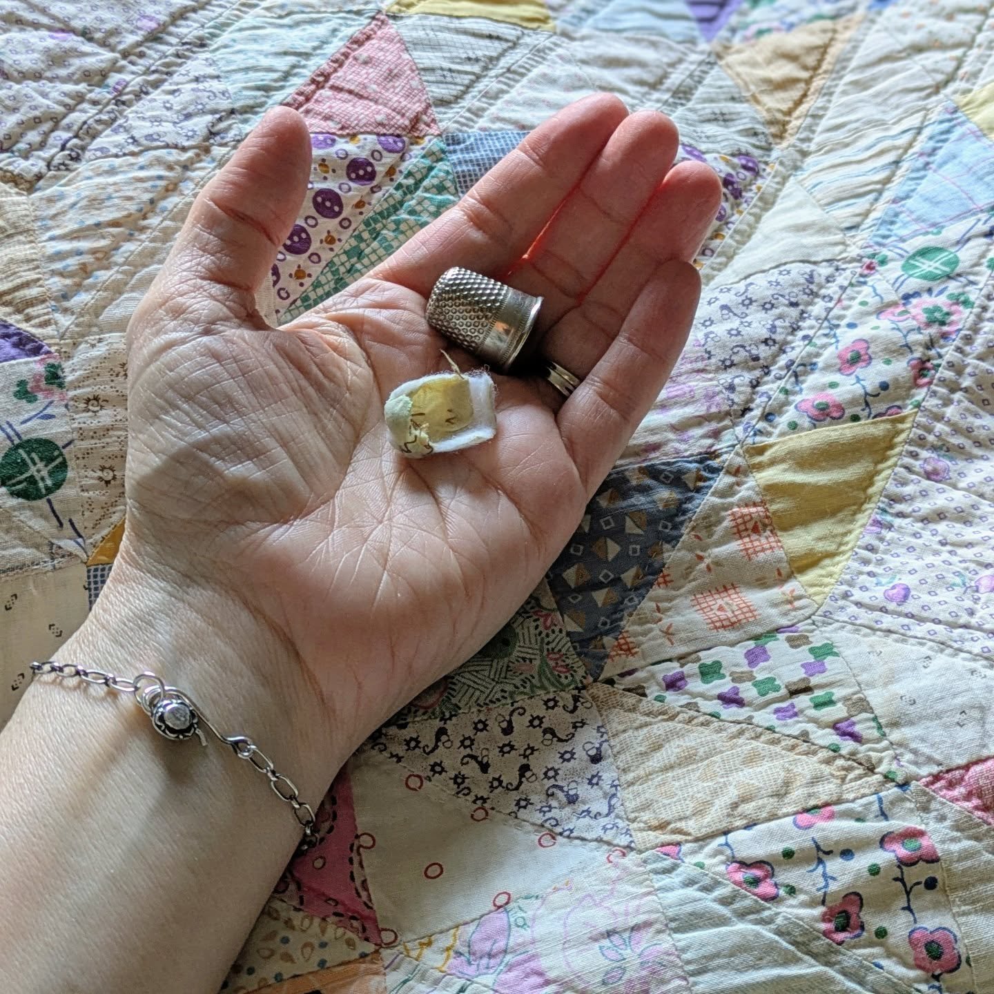 I've been digging around in my many treasure boxes and such and made a discovery. Something I don't remember noticing before. This is one of my grandma's thimbles - my mom's mom I think - and inside is a little bit of scrap batting with some zigzag s