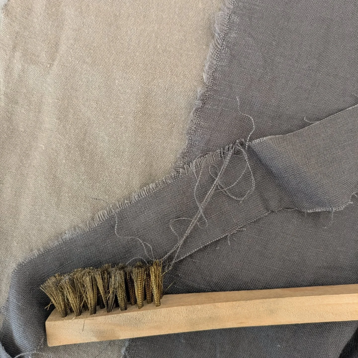 This is the difference between a torn edge and an edge cut then frayed with a wire brush (the piece of scrap under the brush). I also snipped into the frays a bit to make lem less even. 
.
I think this will do? Will find out soon!