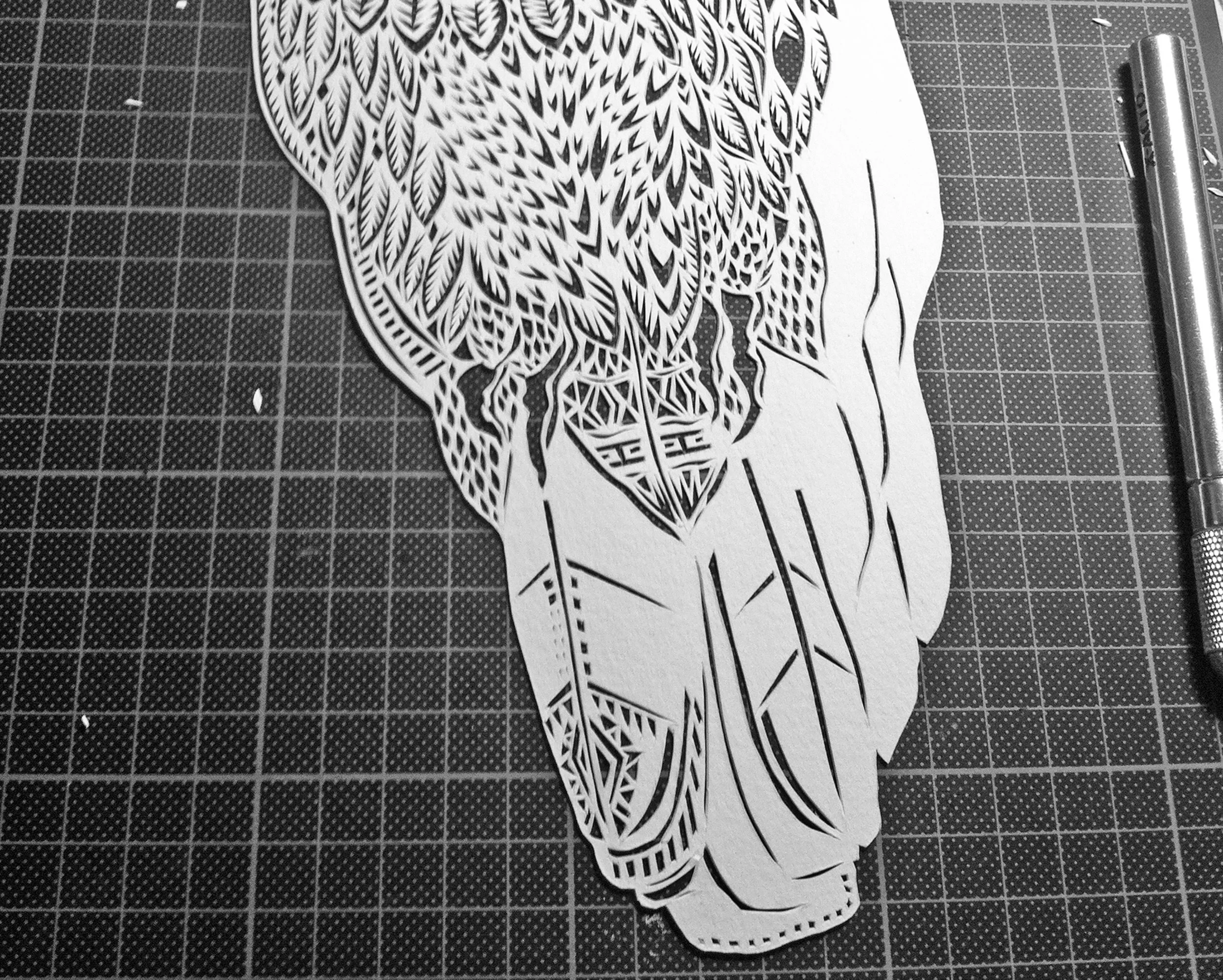 Papercutting in progress! This is going to be the tail of a barn owl. Cutout of paper by Thysart